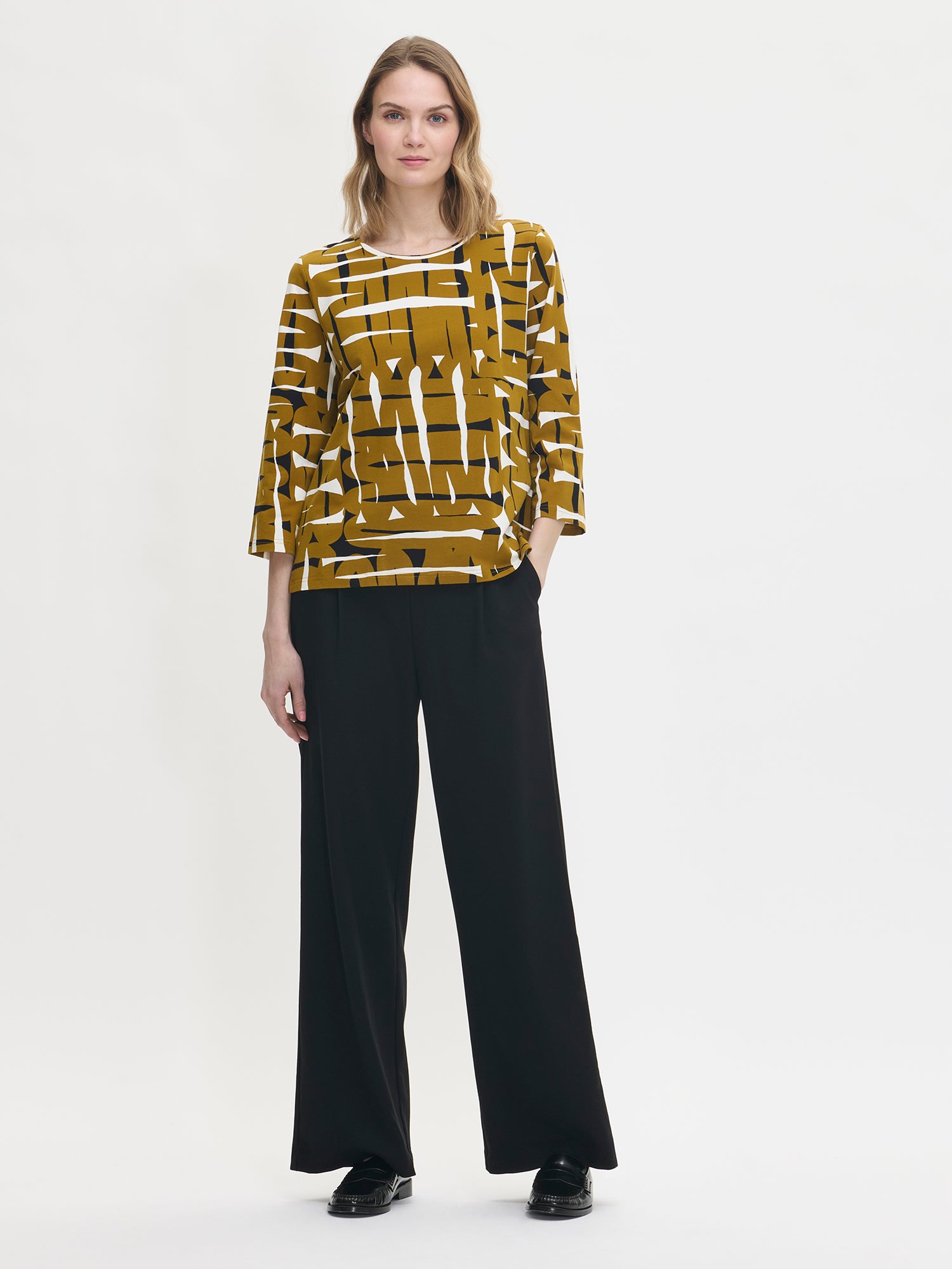 Nanso women's brown Kaiku blouse features a patterned design with a round neckline on a model