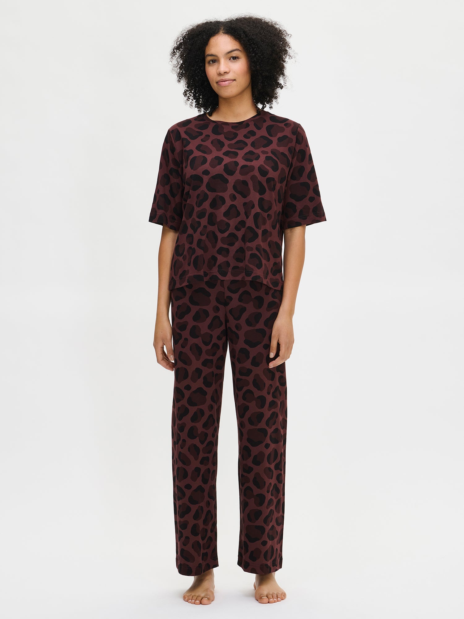 Nanso women’s patterned brown Pantteri trousers and matching top, worn by a model front view.