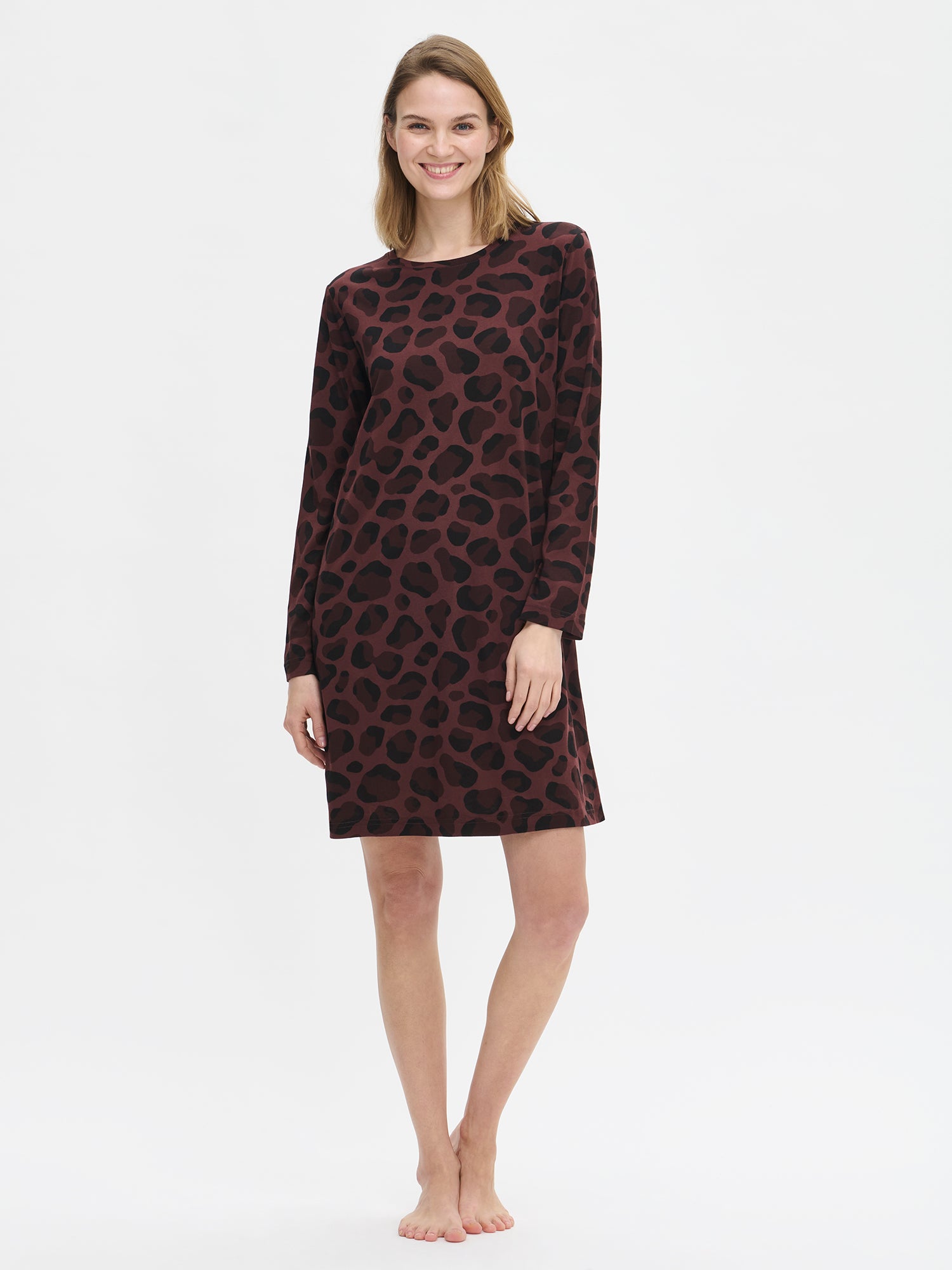 Nanso women’s brown Pantteri nightgown with long sleeves and round neckline, worn by model from the front. The hem falls above the knees.