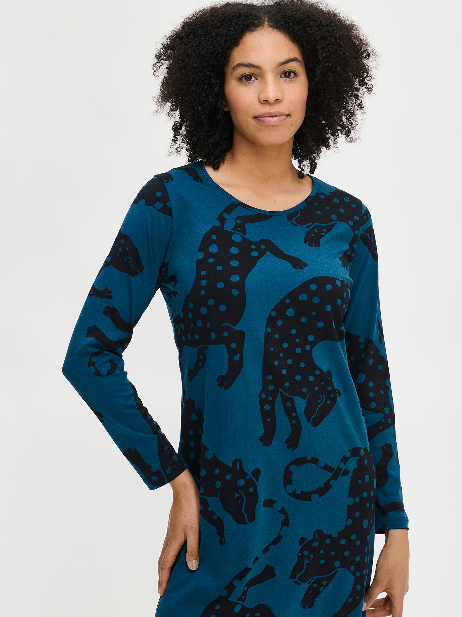 Nanso women’s long blue Leonora nightgown with full-length sleeves and round neckline, worn by model from the front. Hemline reaches ankles.