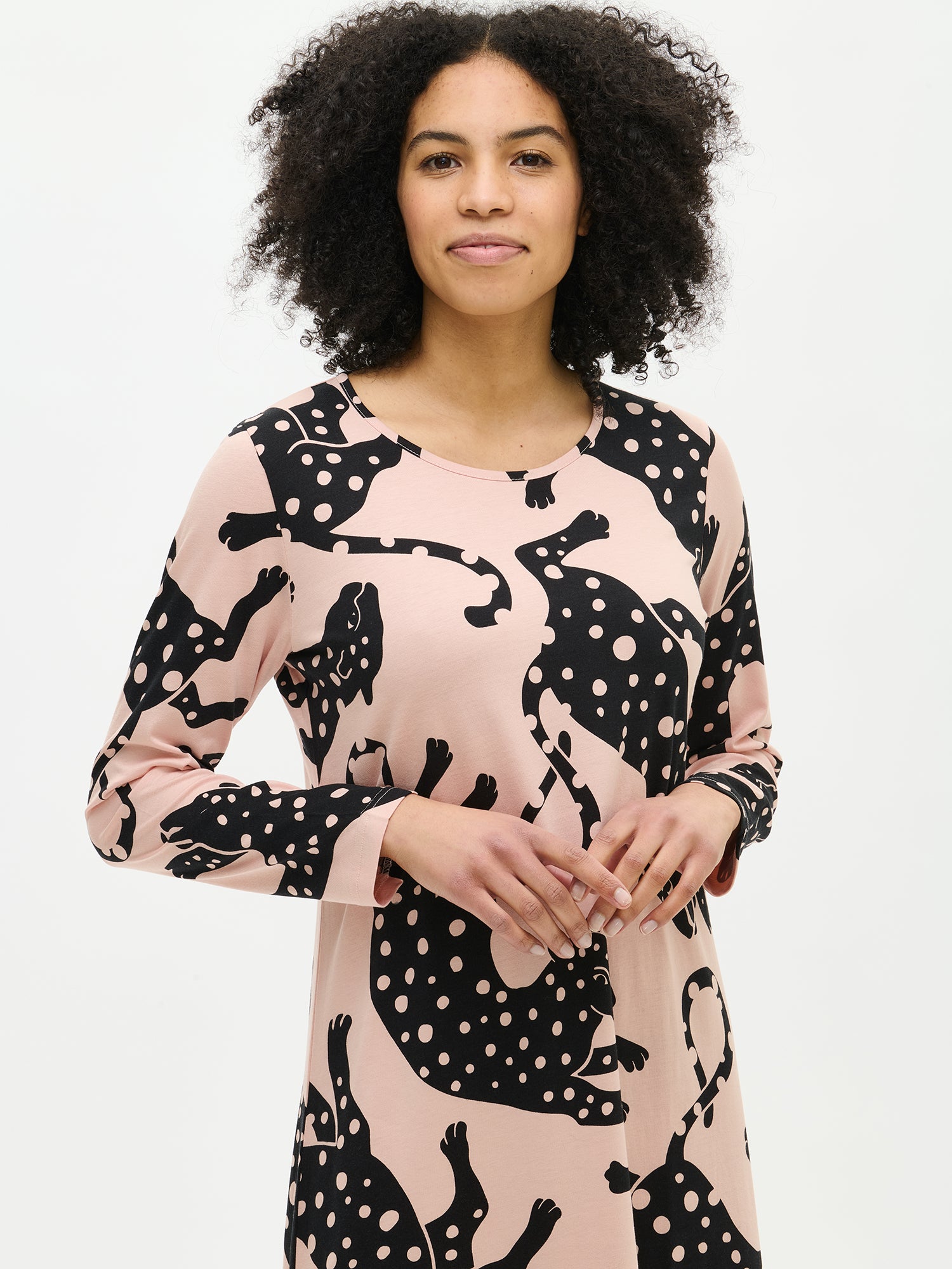 Nanso women’s long pink Leonora nightgown with full-length sleeves and round neckline, worn by model from the front. Hemline reaches ankles.