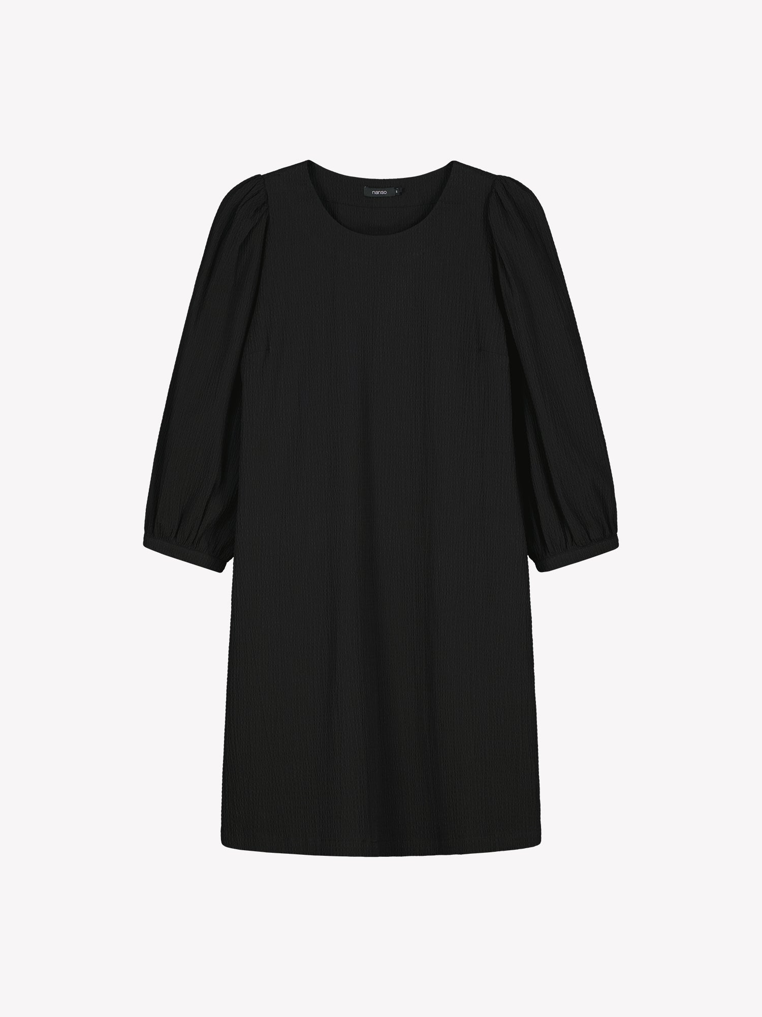 Nanso women’s solid black Bianca dress in cotton–elastane, round neckline, gathered sleeves and pockets, knee-length, product photo front view.