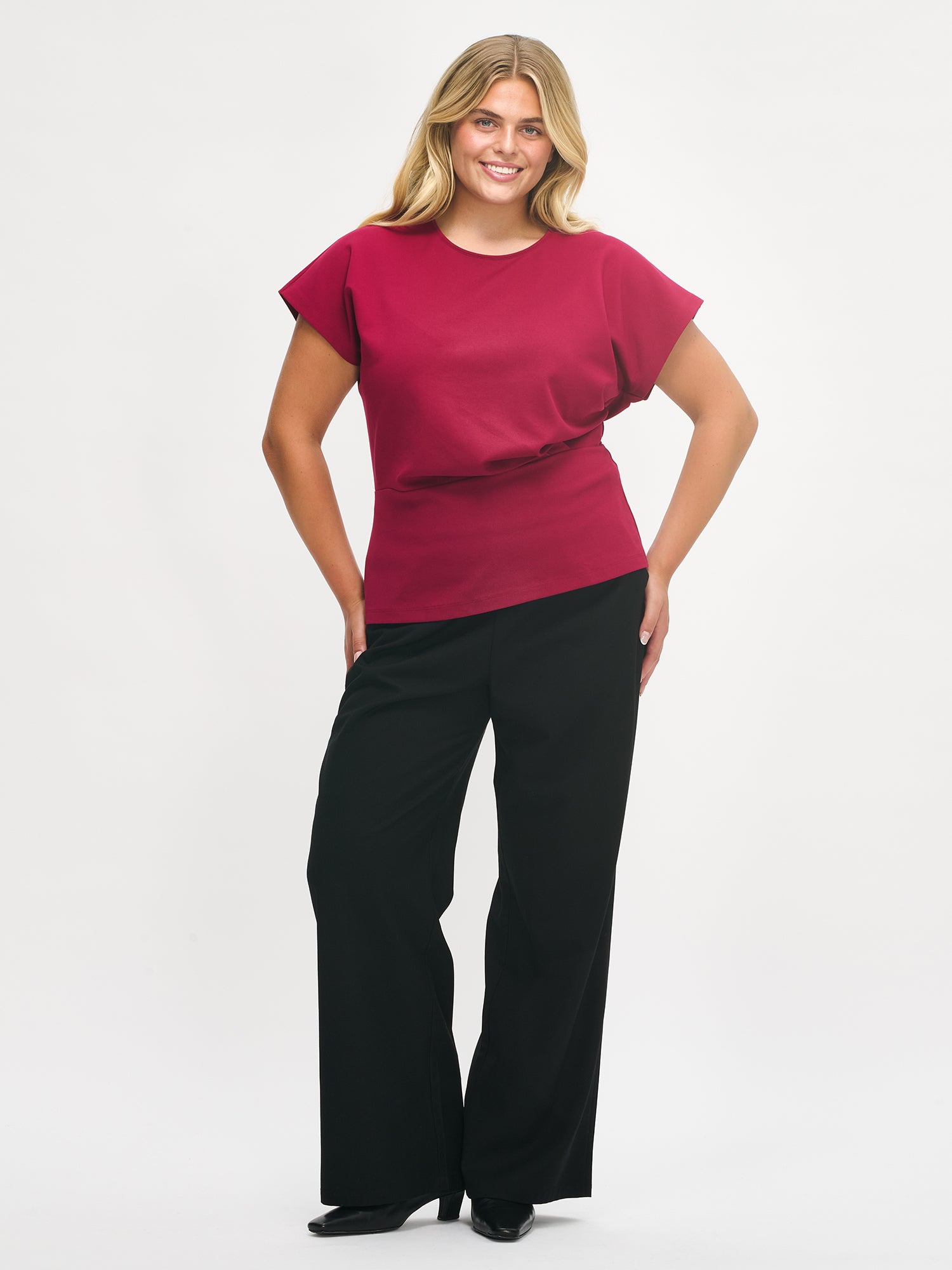 Nanso women’s Elegia blouse – timeless Finnish design in soft burgundy knit with cap sleeves and pleated waist. Image in size XL, front