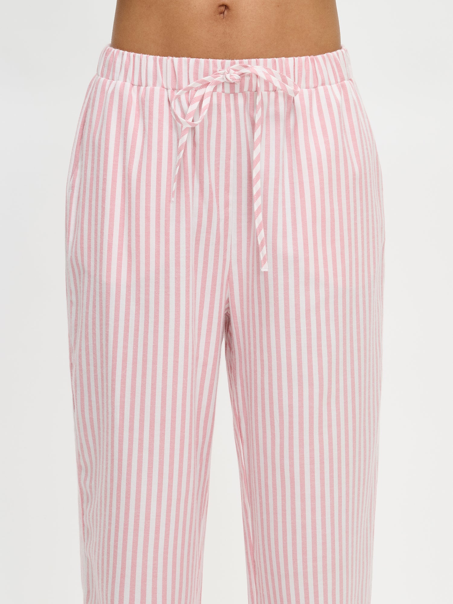 Nanso Polka pink women’s striped flannel pants with elastic waist and drawstring, close-up image.