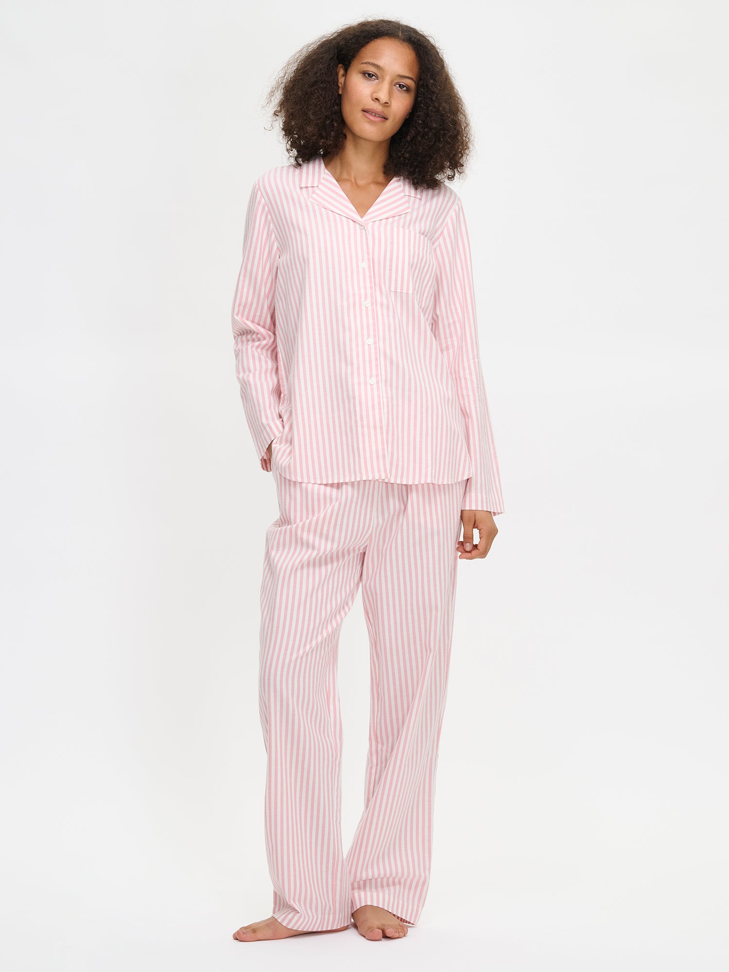 Nanso Polka pink women’s full-length striped flannel pants, worn by model.