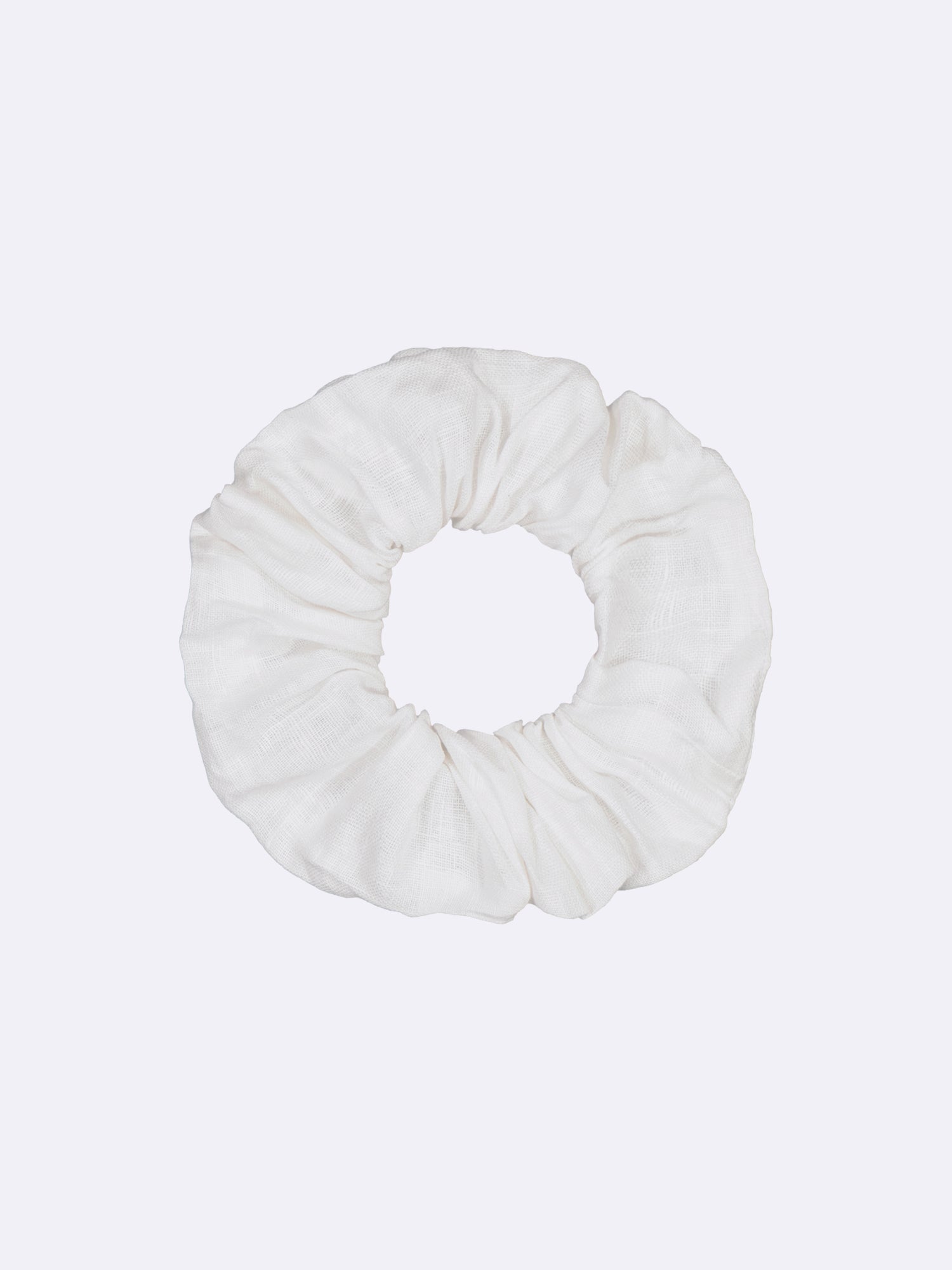 This elegant and timeless beige linen scrunchie, made from surplus material, showcases a beautiful combination of style and sustainability.