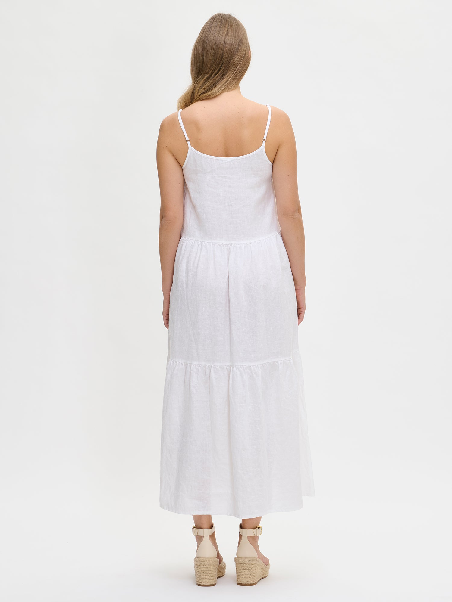 Woman wearing a white dress on a white background