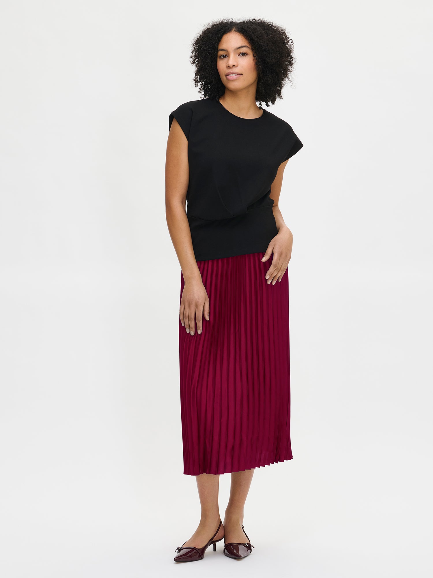 Nanso's elegant Taite skirt for women features a graceful drape in burgundy