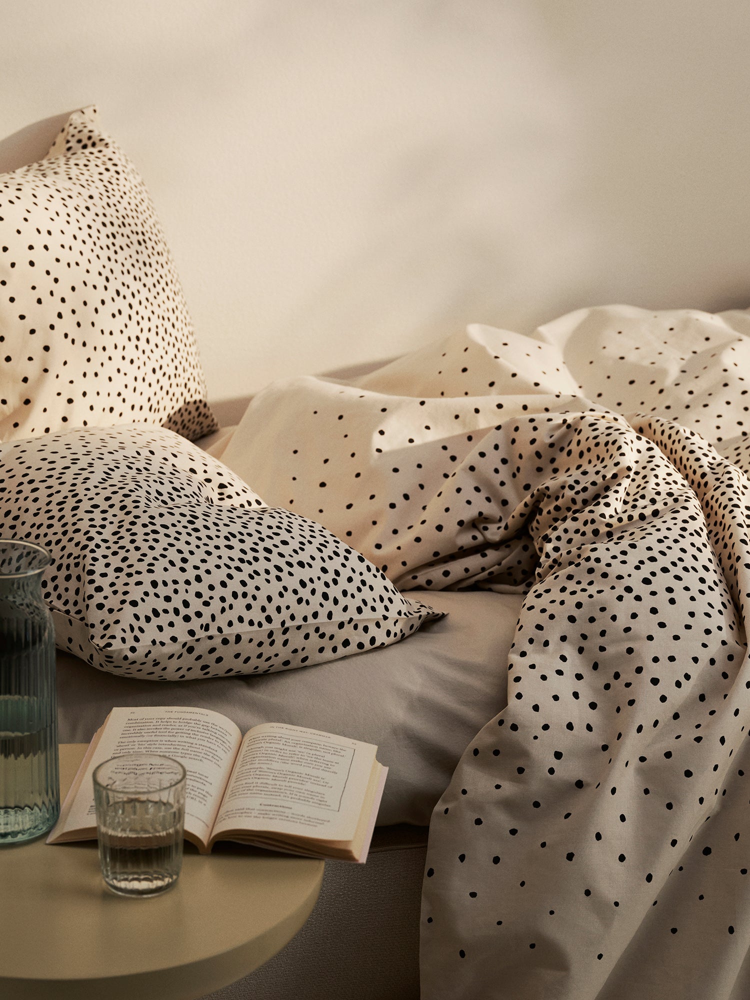 Täplä duvet cover set in beige with charming dots, in a cosy home decor picture