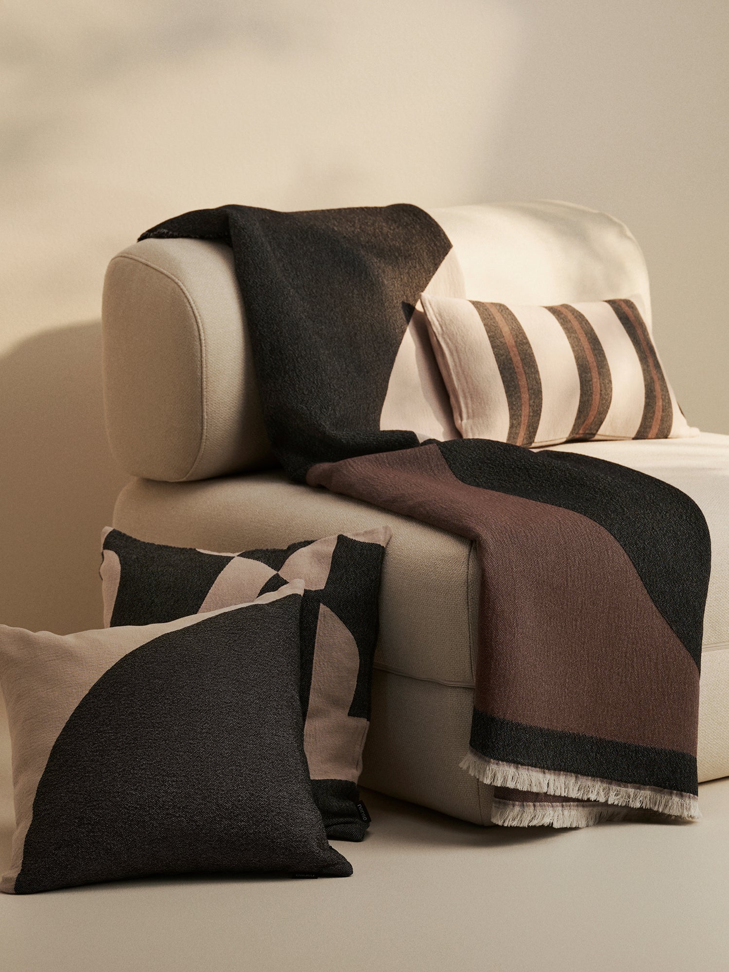 Nanso beautiful Art blanket with a neutral toned stylish pattern woven using jacquard technique, pictured in a beautiful home decor setting with throw pillows.