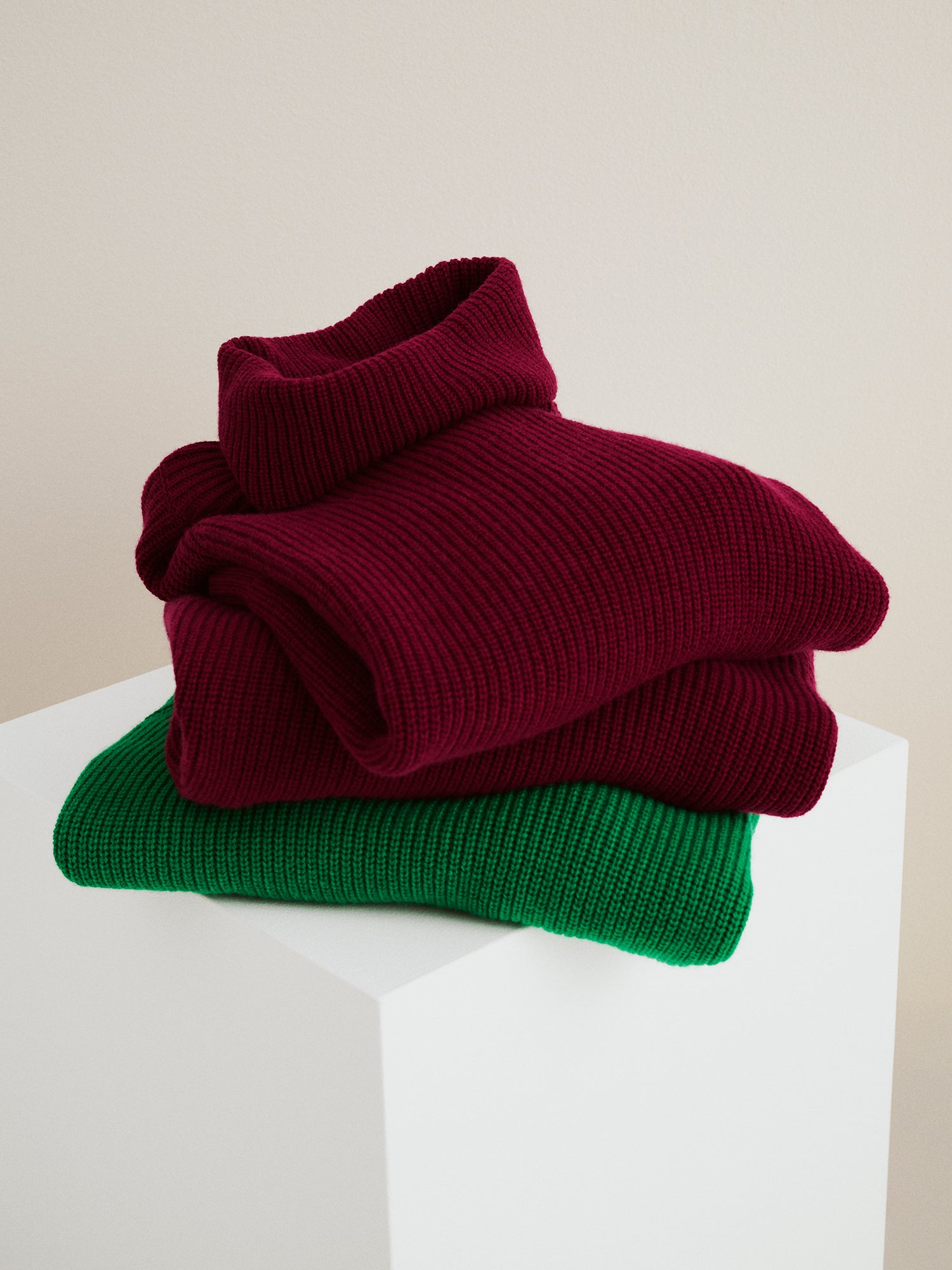 Nanso's relaxed burgundy Pamela knit tunic on a pile