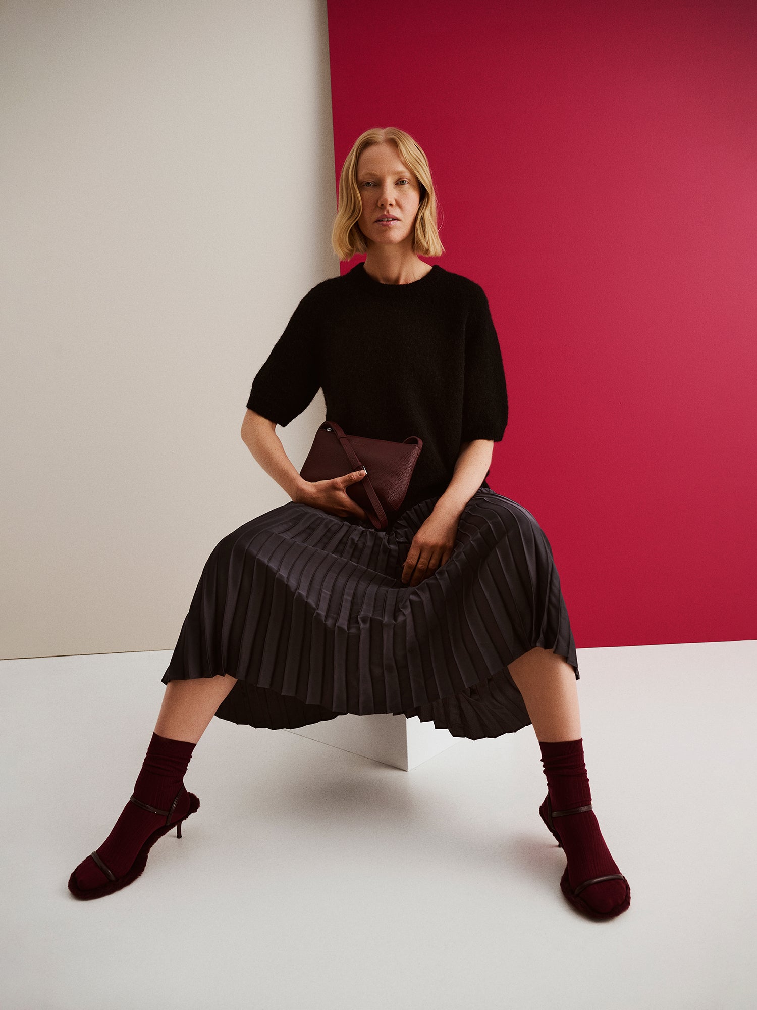Nanso's elegant Taite skirt for women features a graceful drape in a classic black, on a model