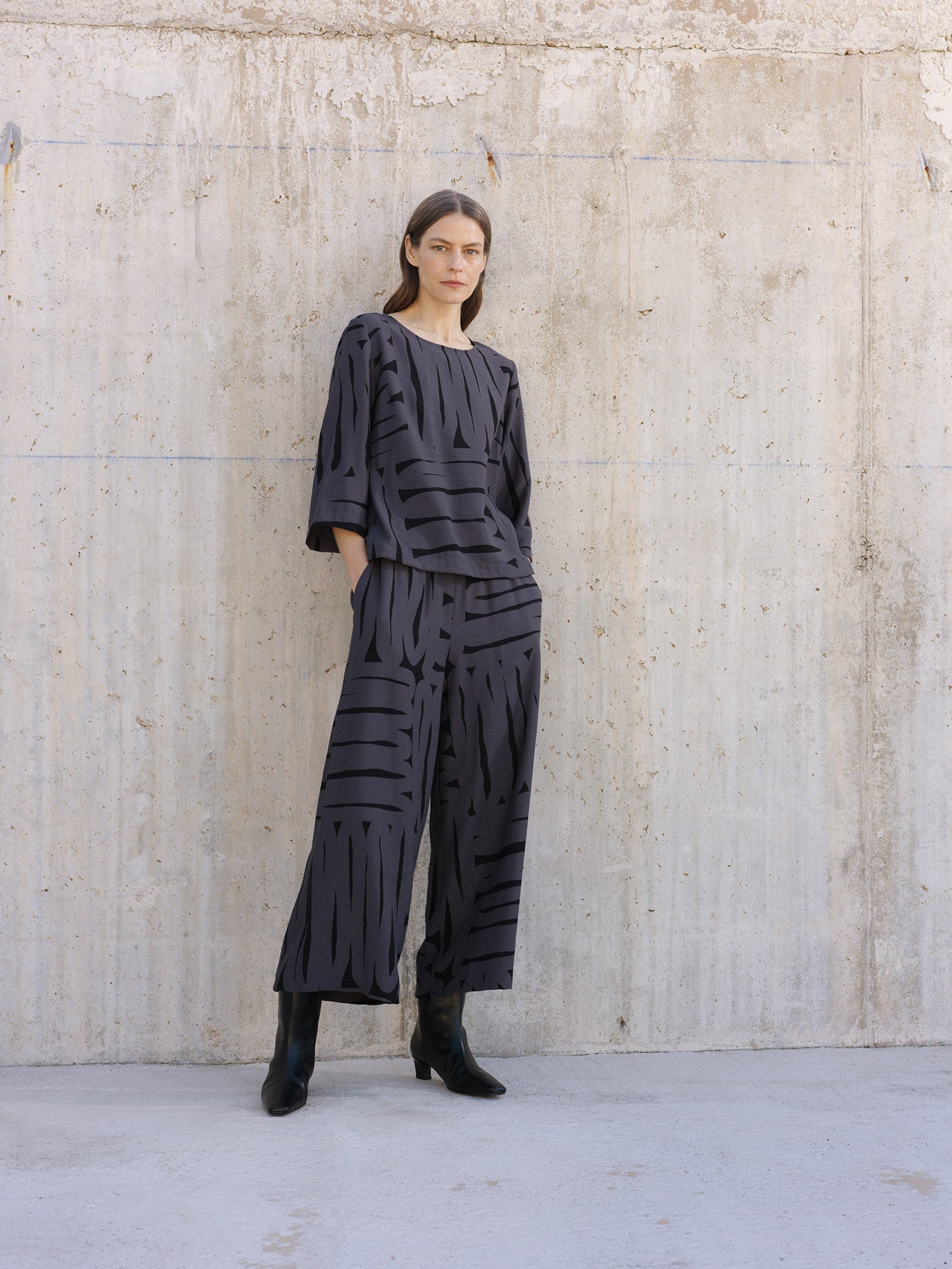 Nanso women's gray Kaiku blouse features a patterned design, on a model