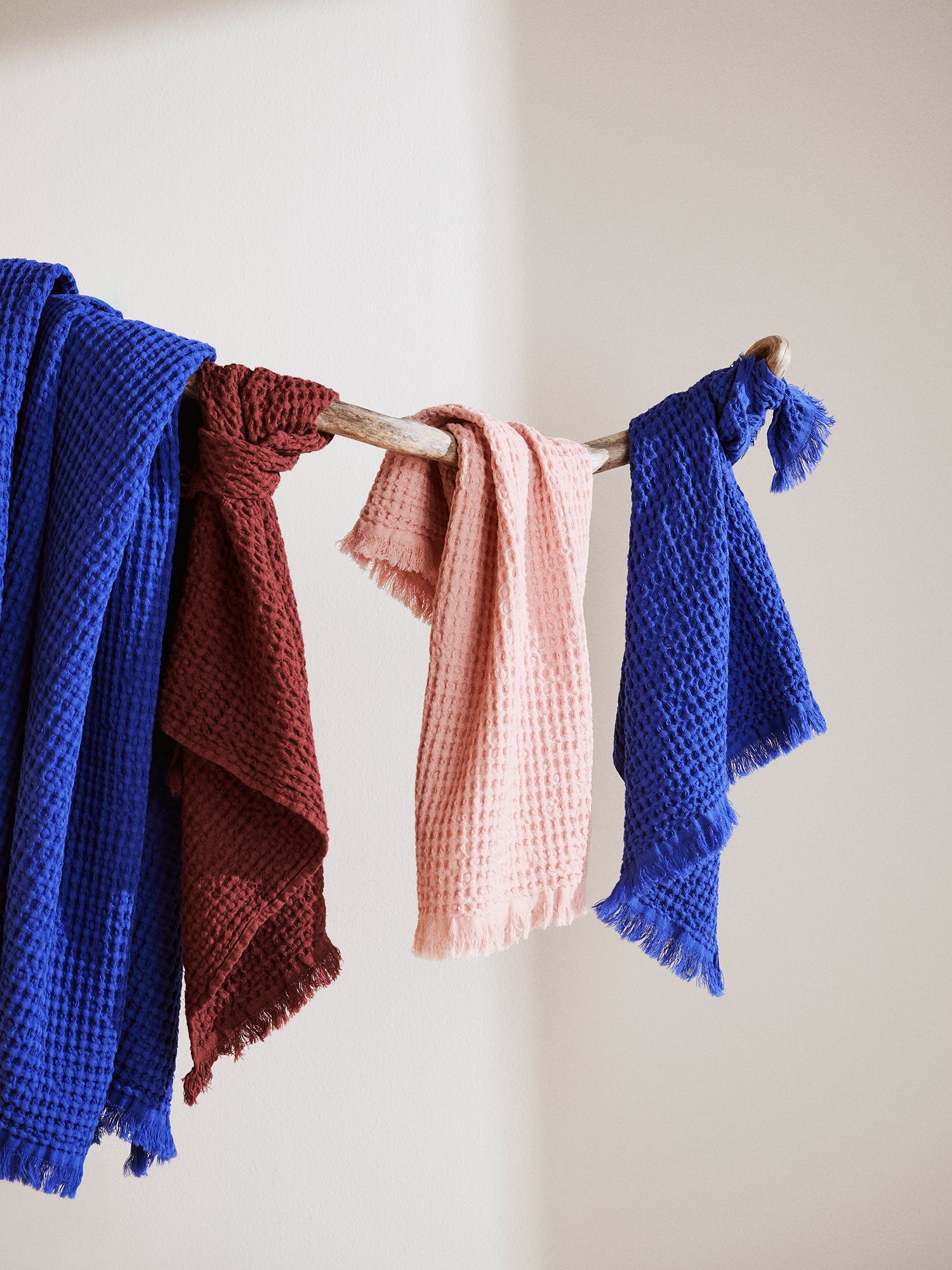 Nanso home's Vohveli Bath towel in rose on a hanger