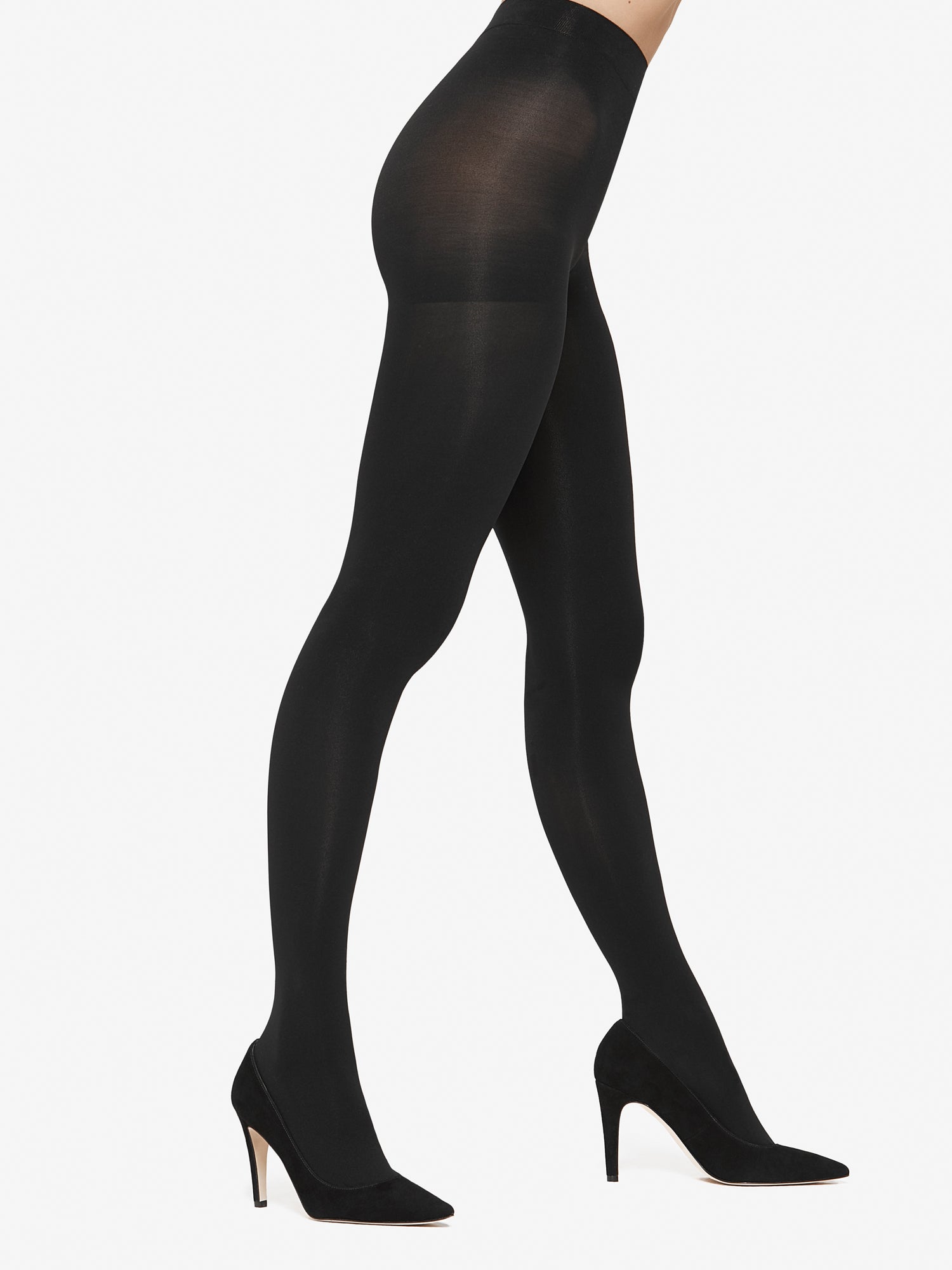 Vogue black velvet matt 60 denier medium shaping tights with comfortable shaping effect, product picture on a model pictured from the side with high heels.