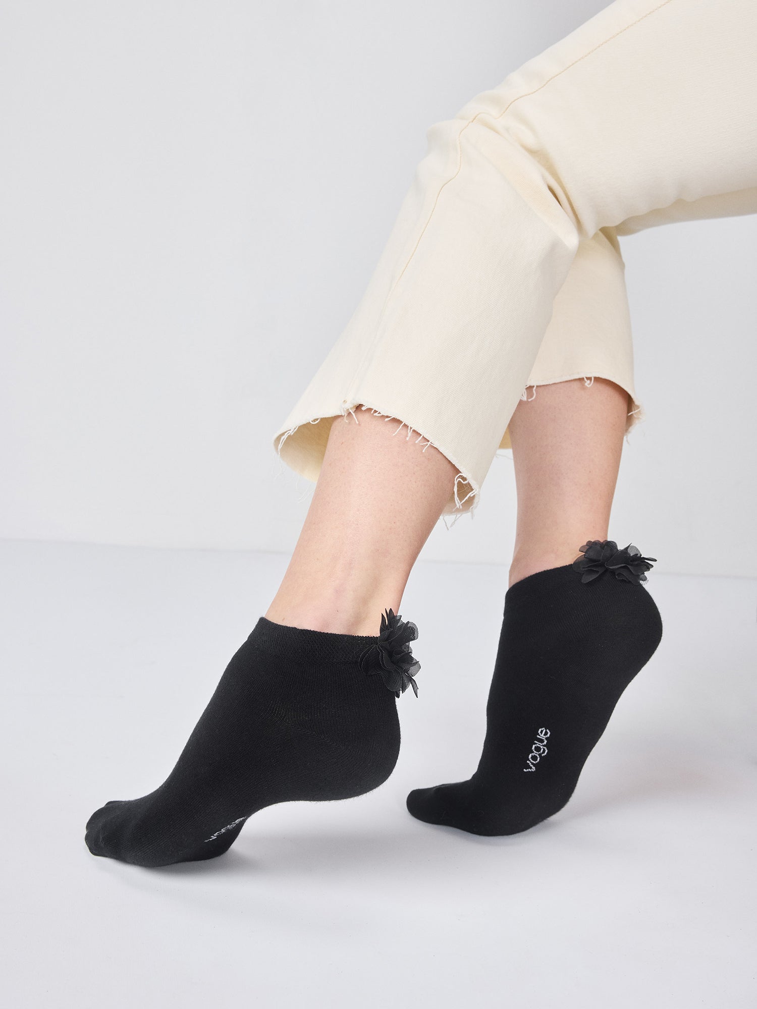 Vogue women's Cecilia sneaker ankle socks with a ruffly flower detail from side.