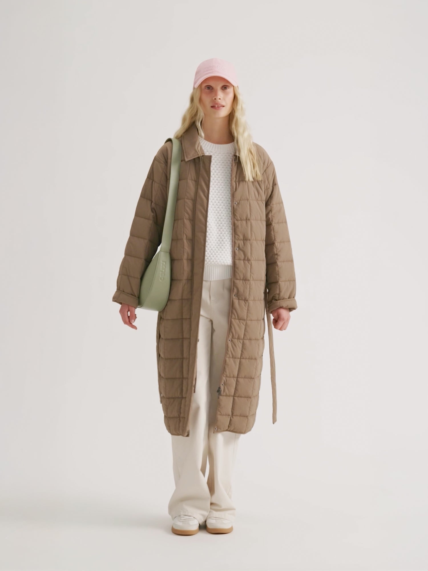 Woman wearing the MARJE Quilted Coat in beige