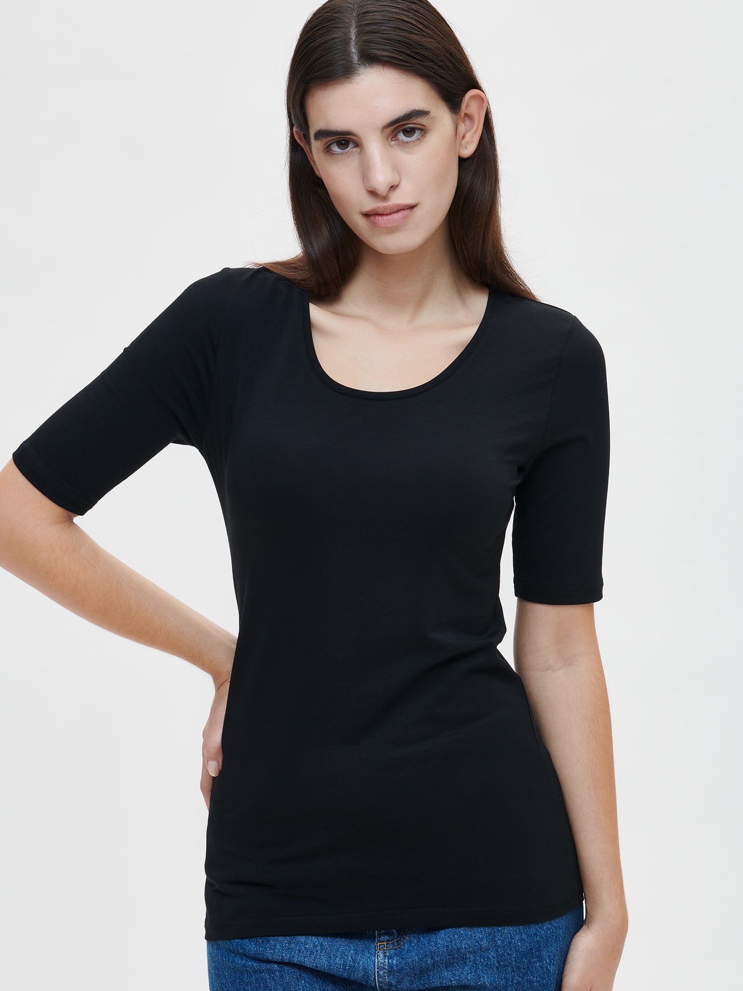 This versatile and stylish women's BASIC T-shirt in black is perfect for everyday wear. Its simple yet timeless design is suitable for any occasion. Worn by a model in size S.