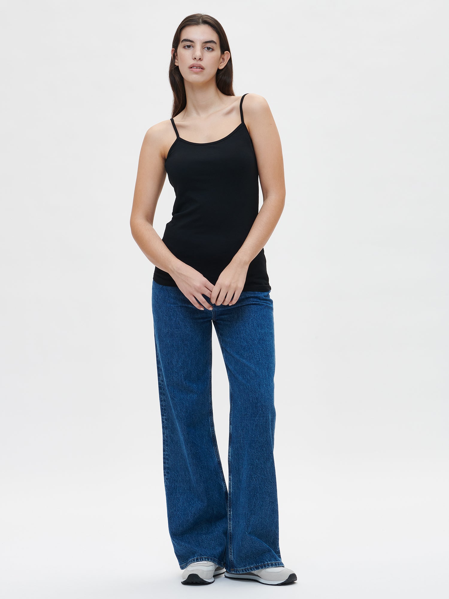 Nanso women's high quality black Basic top with thin straps crafted from soft, stretchy cotton-elastane knit, on a model with jeans pictured from the front.