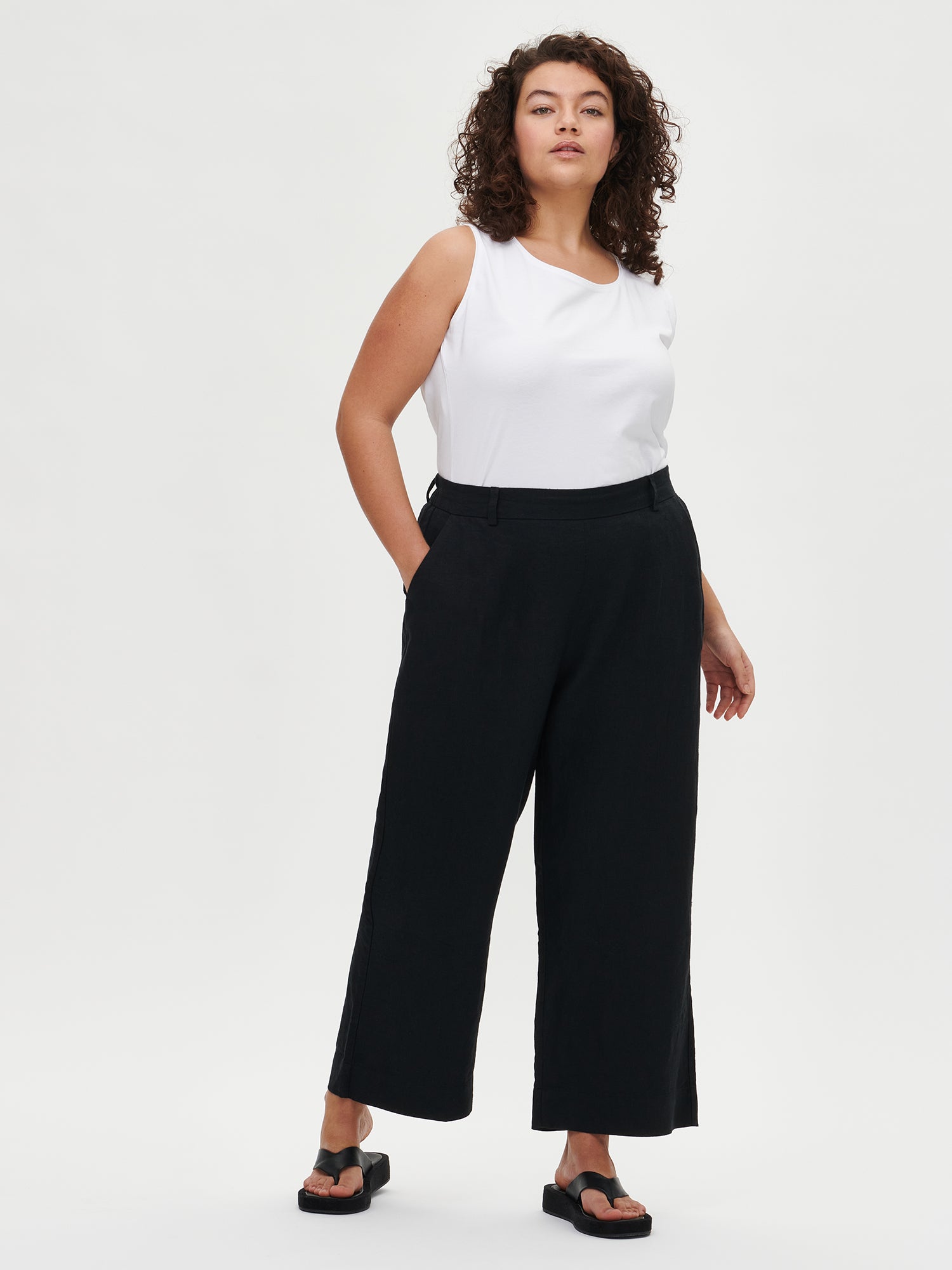 Nanso women's white Basic top with comfortable wide straps and a timeless silhouette. Crafted from soft, stretchy organic cotton-elastane knit.  On a plus size model from the front.