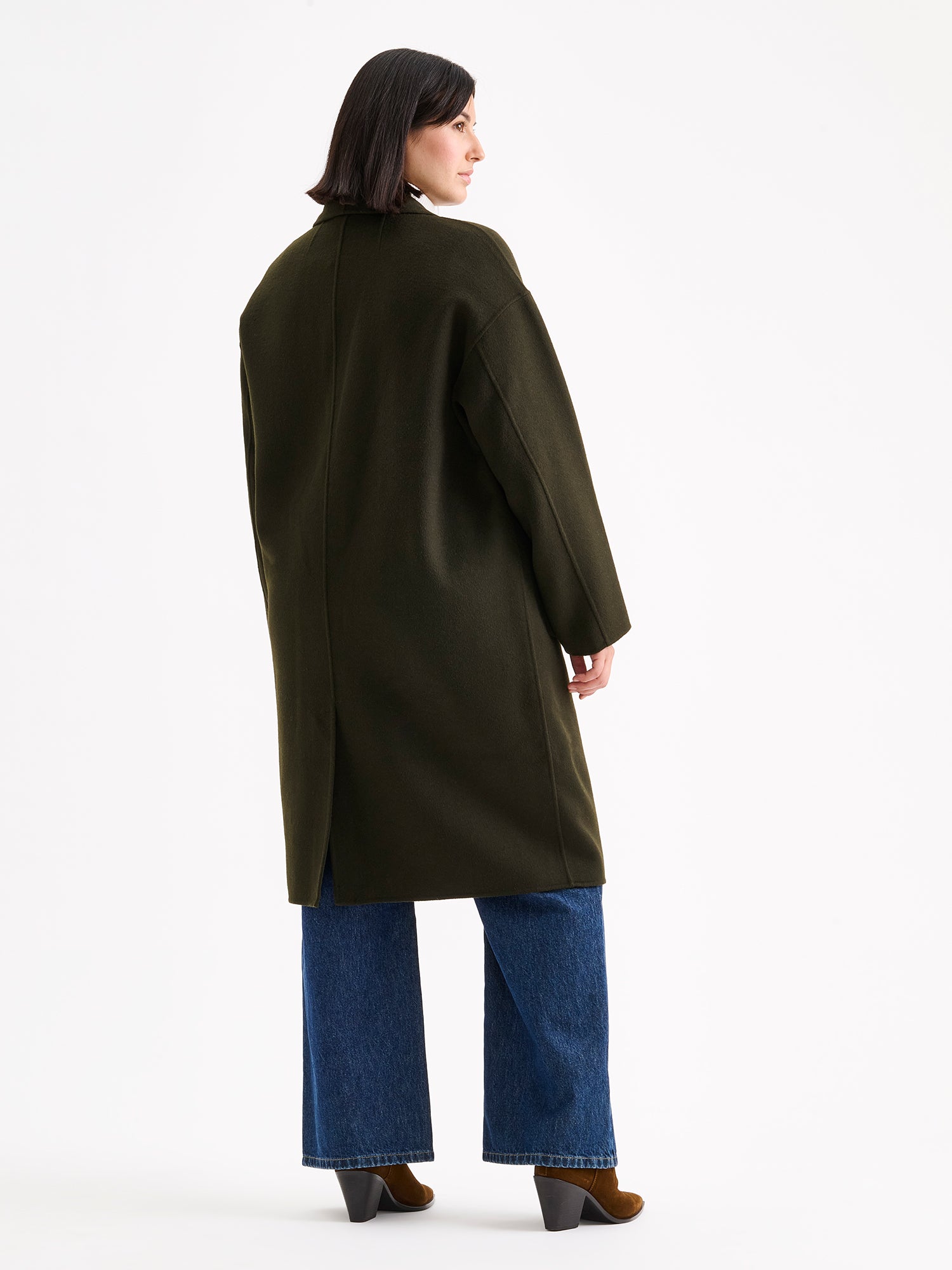 Nanso women's stylish and timeless olive green YLLE wool coat on a model with a white turtle neck and jeans, from the backside