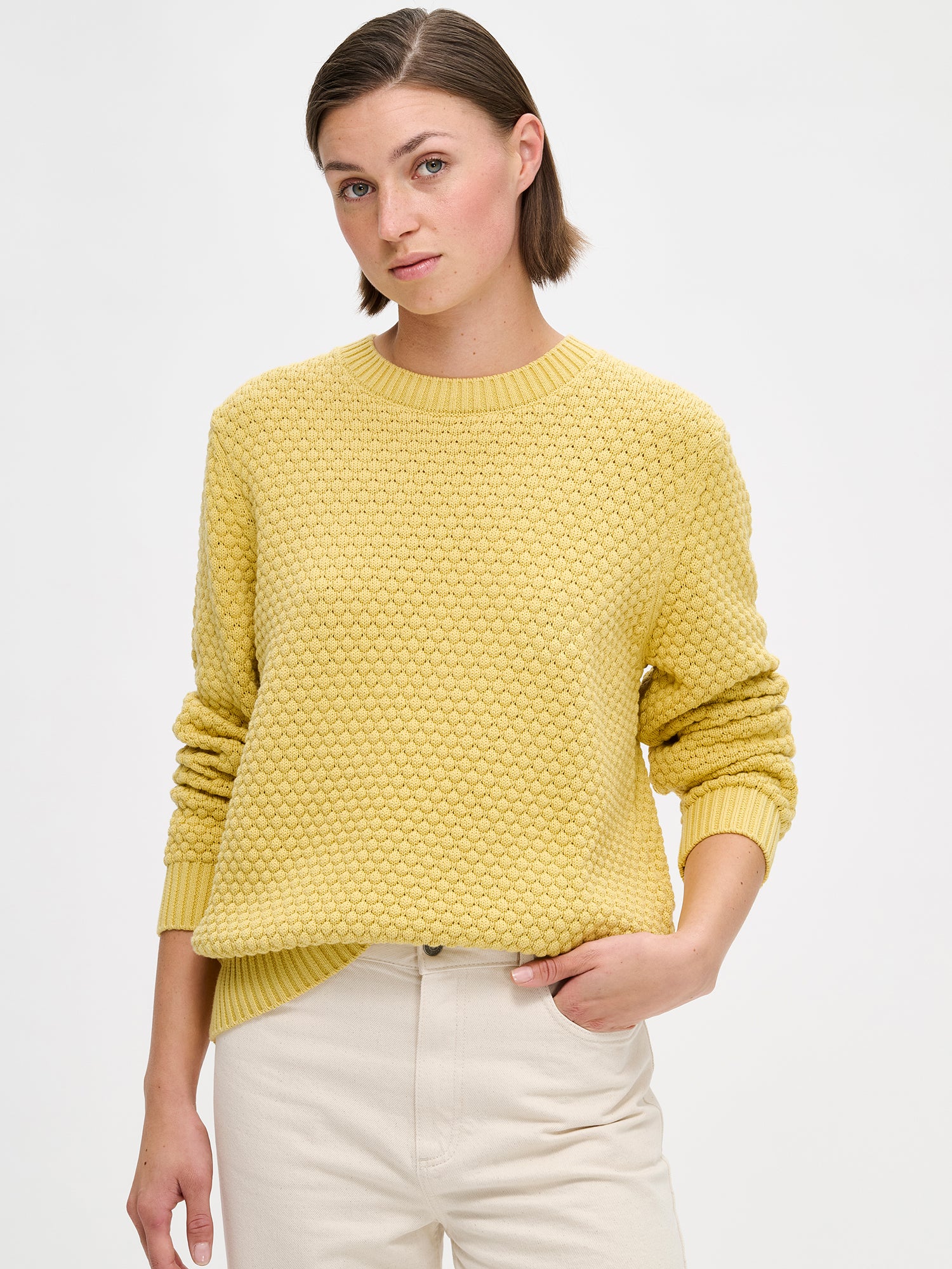 Women's KUMPU Knit Sweater in yellow on amodel, close-up.