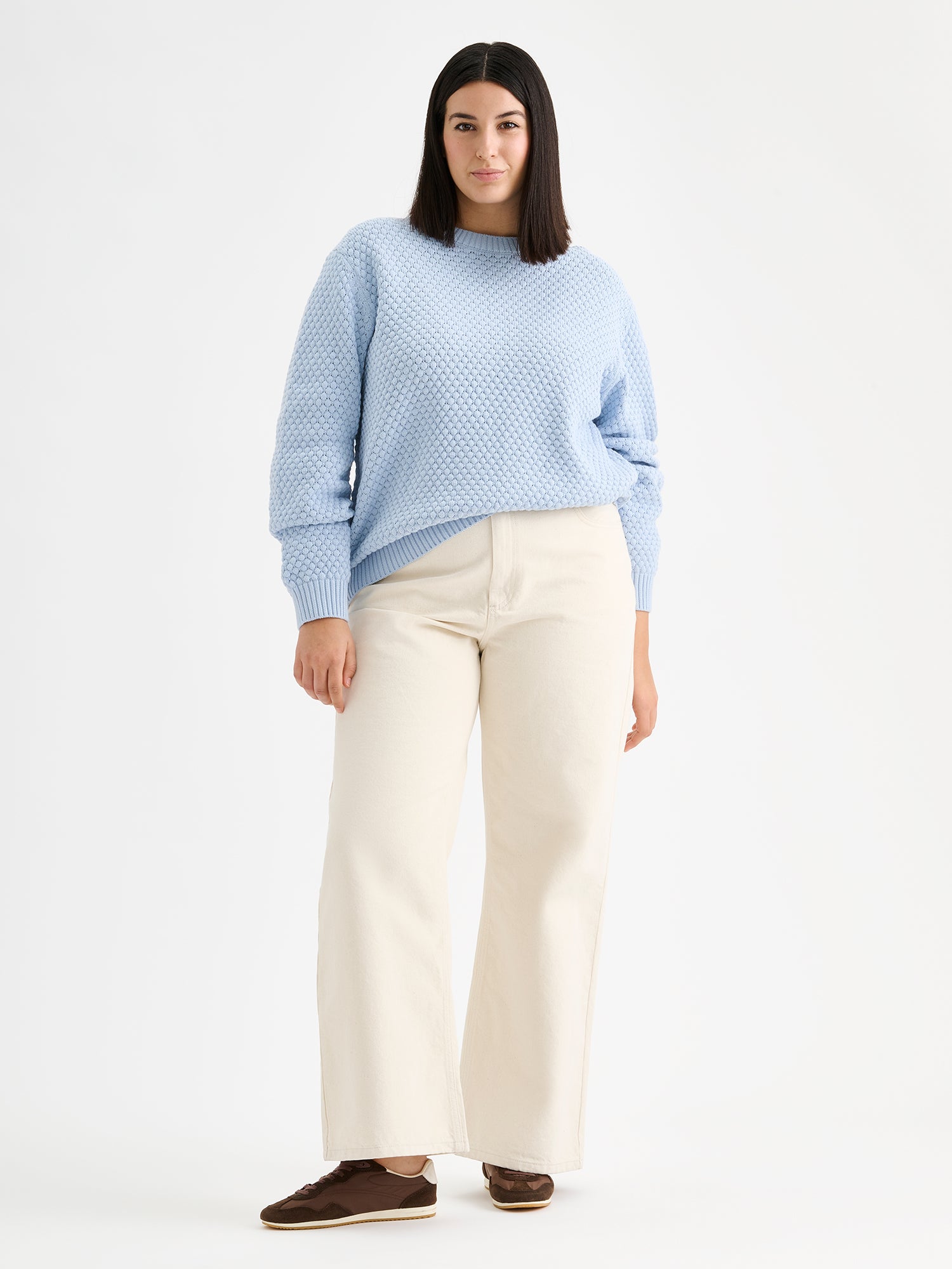 Women's KUMPU Knit Sweater in light blue on a model with light jeans