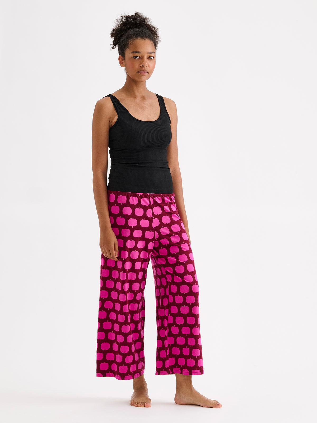 Nanso women's Heila ribbed top in black on a model with pink patterned pants. | S - 177cm