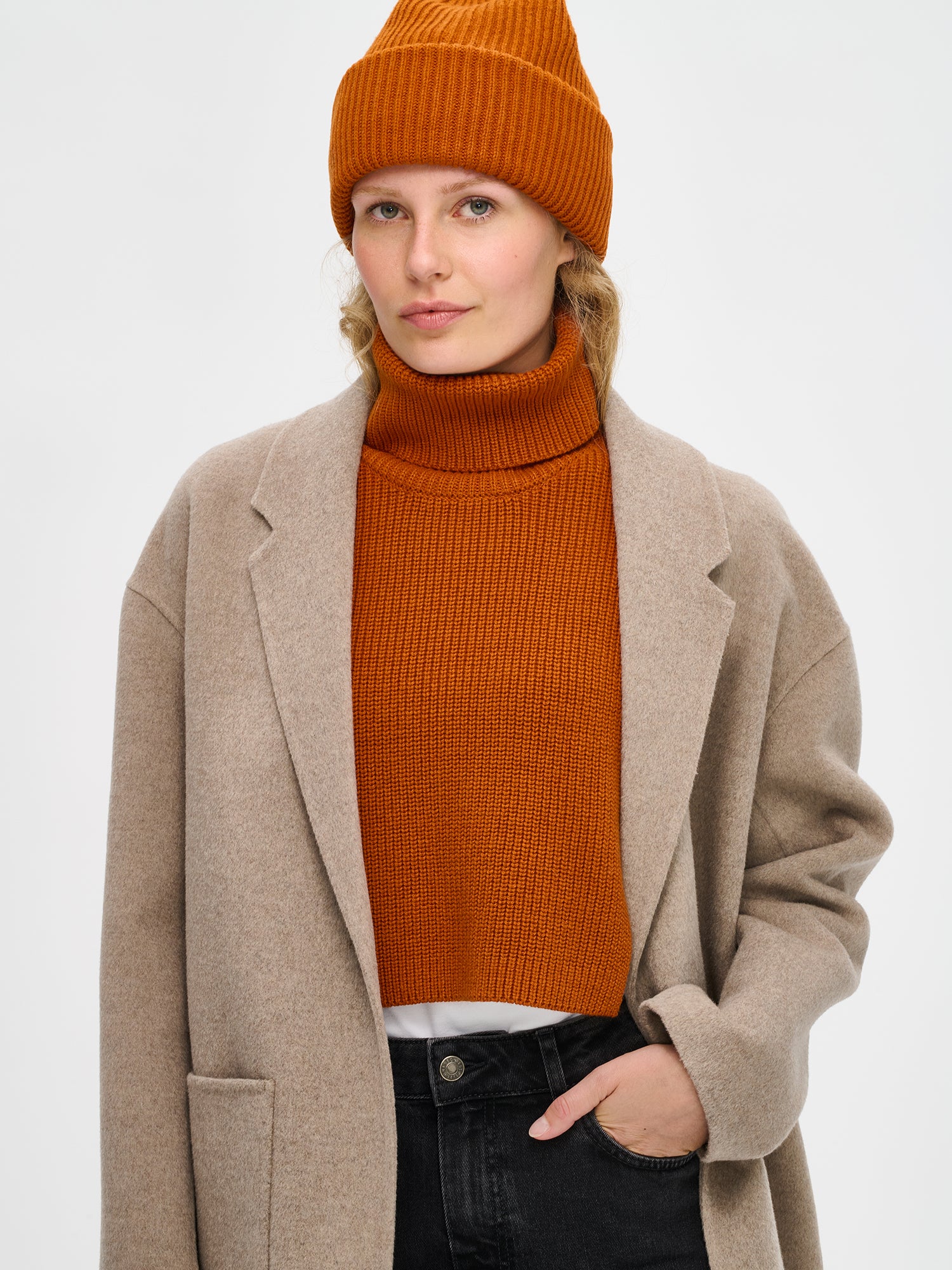 Women's brown Utu turtle scarf is crafted from a comfortable patent knit and features a foldable turtle collar. On a model