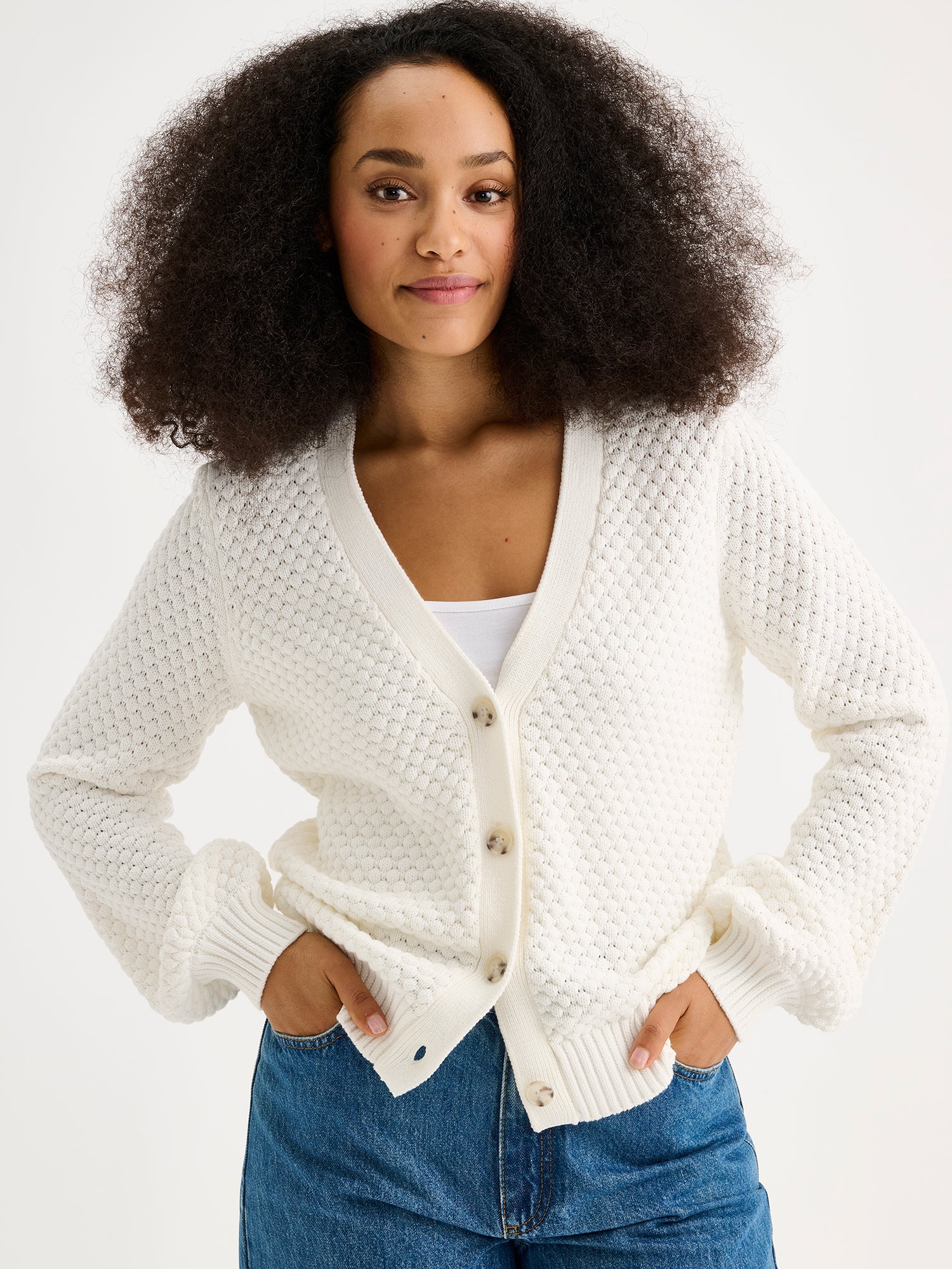 women's KUMPU Knit Cardigan in off white on a model with jeans, close-up