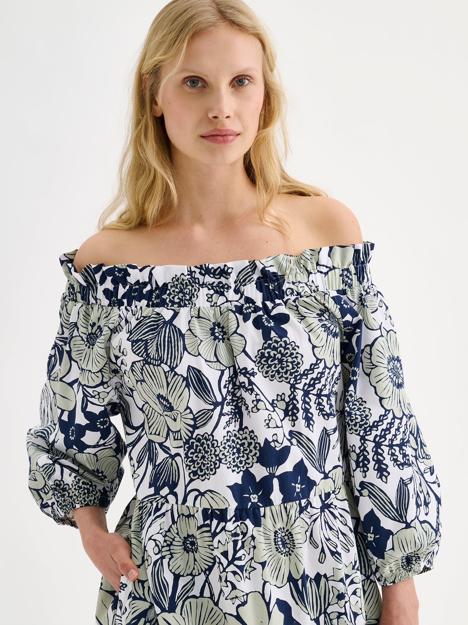 Nanso women's beautifully relaxed floral patterned summer dress, the HUVILA Long Dress, on a model with blonde hair, close-up.