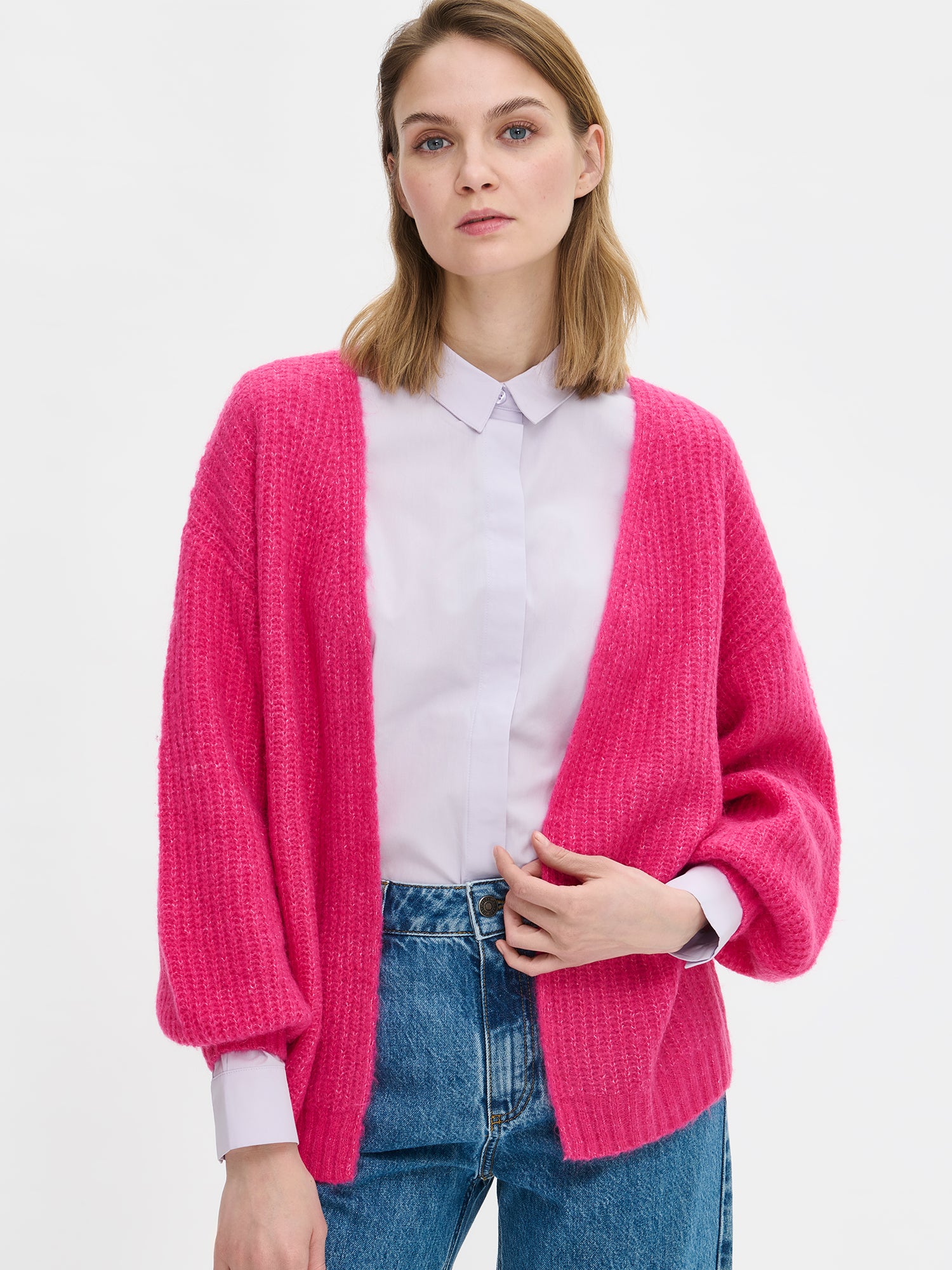 Nanso's women's luxurious pink knit Karamelli cardigan, on a model.
