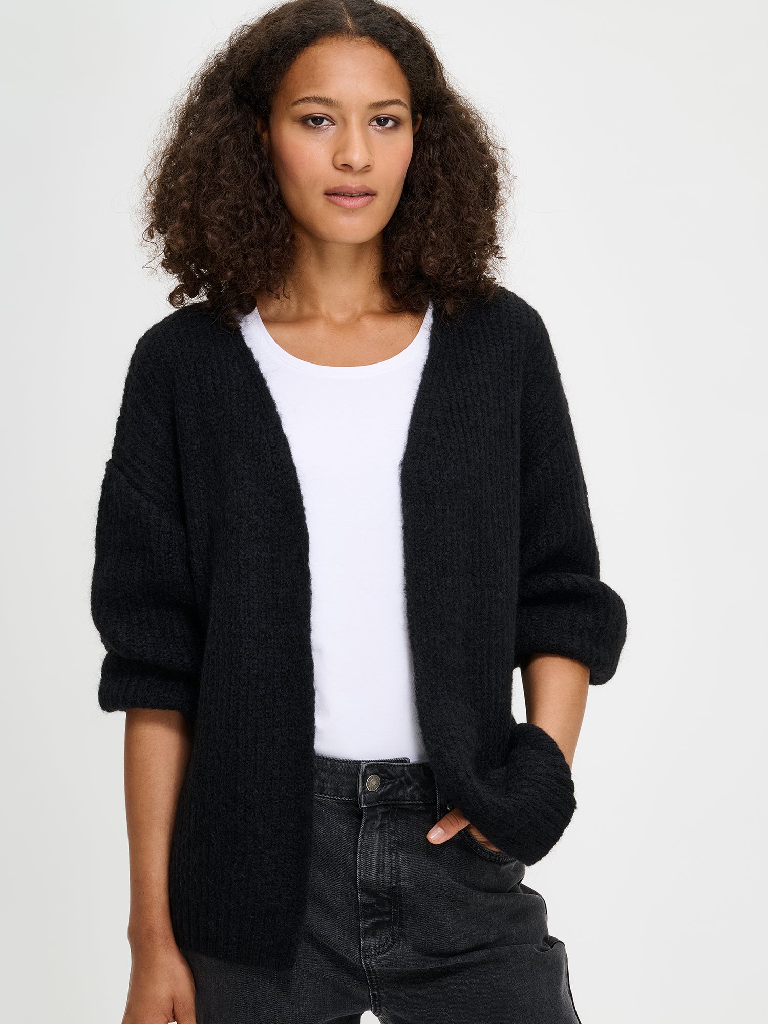 Nanso's women's luxurious  black knit Karamelli cardigan, on a model