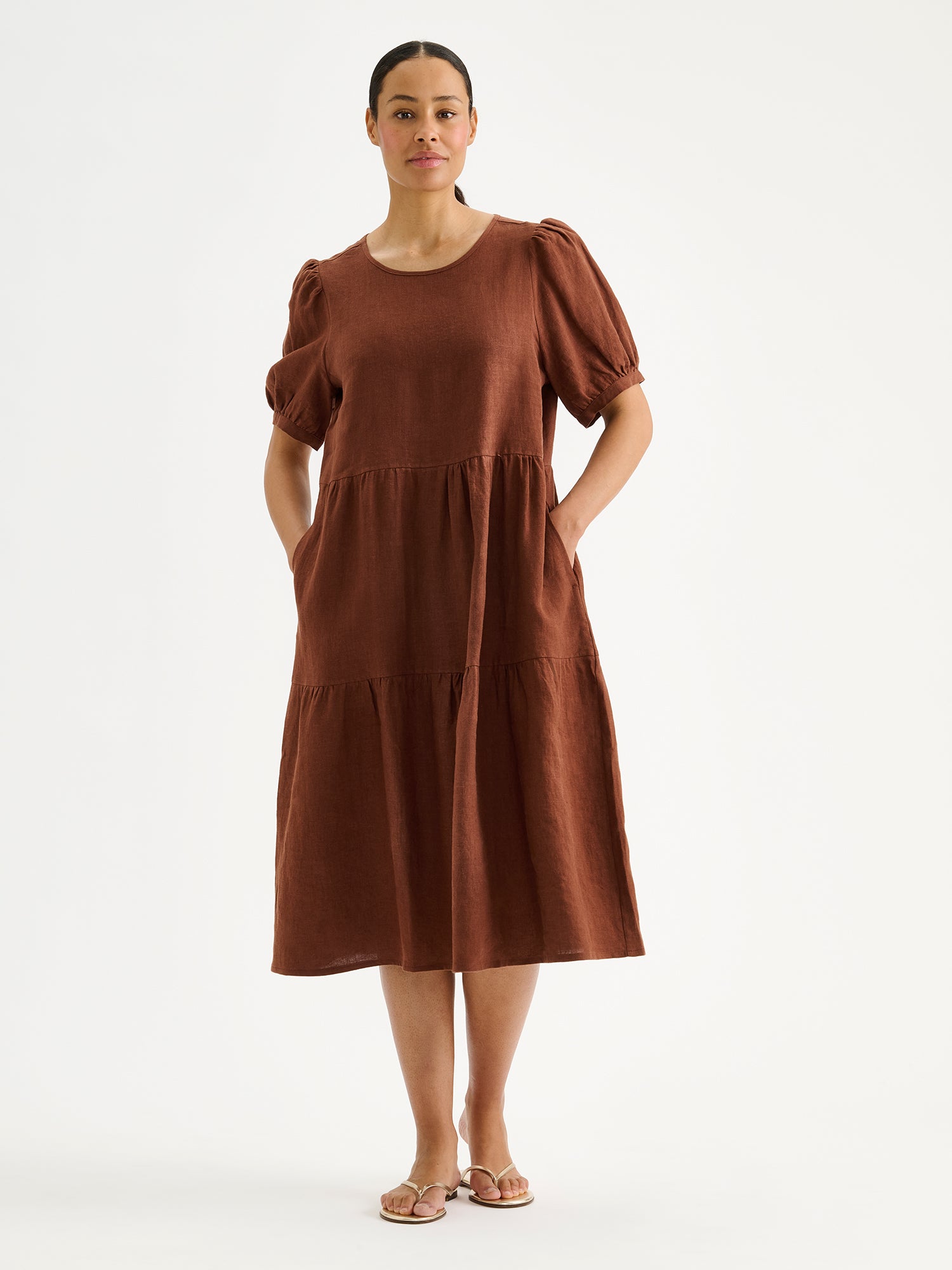 Nanso women's beautiful brown Sarastus midi linen dress features voluminous frill layers and short puff sleeves on a model