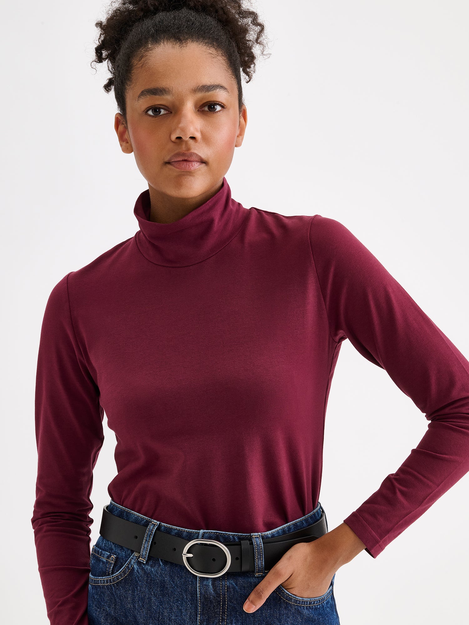 Women's Mari jersey turtleneck in wine red on a model with jeans, close-up