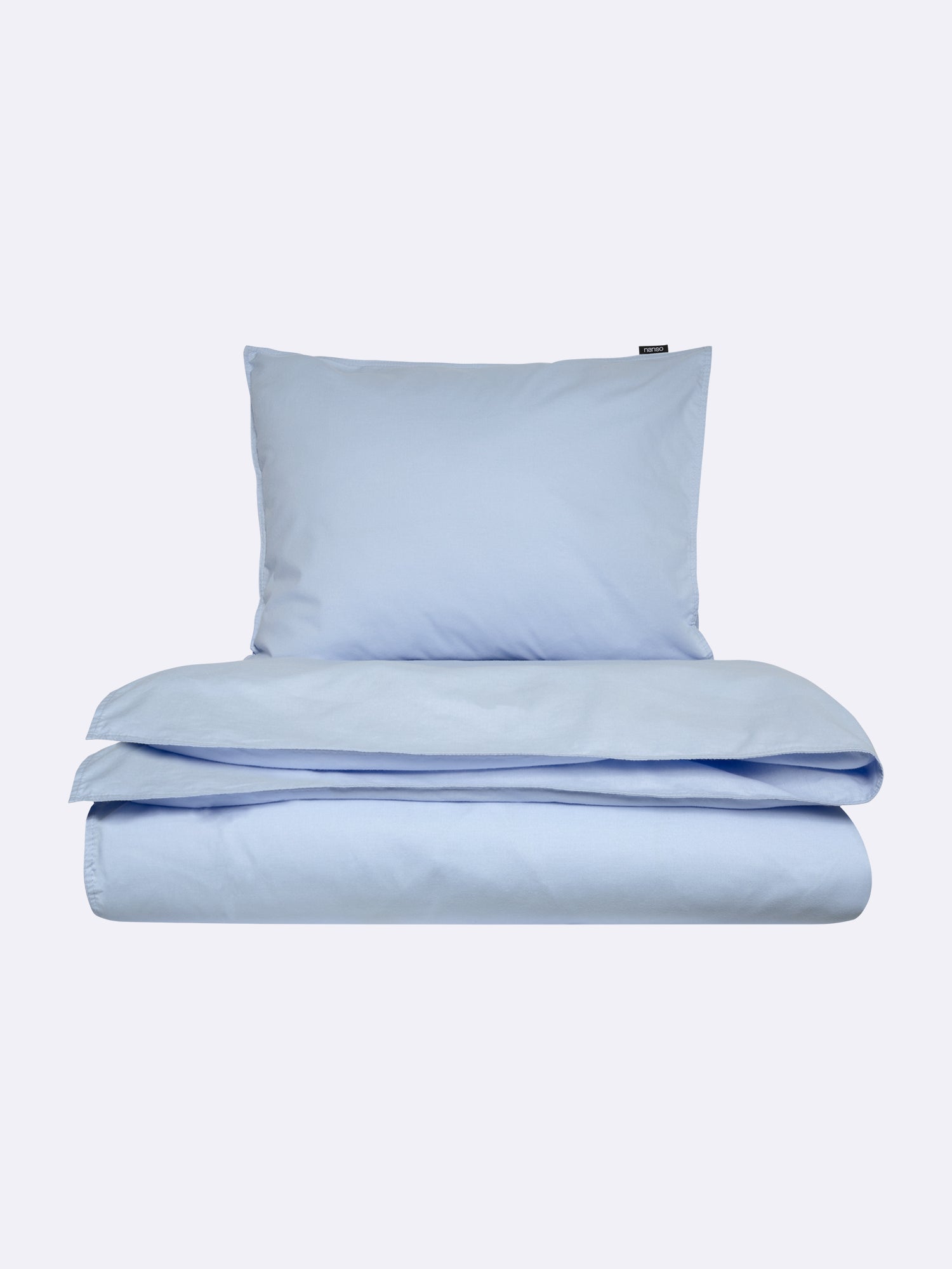 Nanso home's UNI duvet cover in light blue folded.