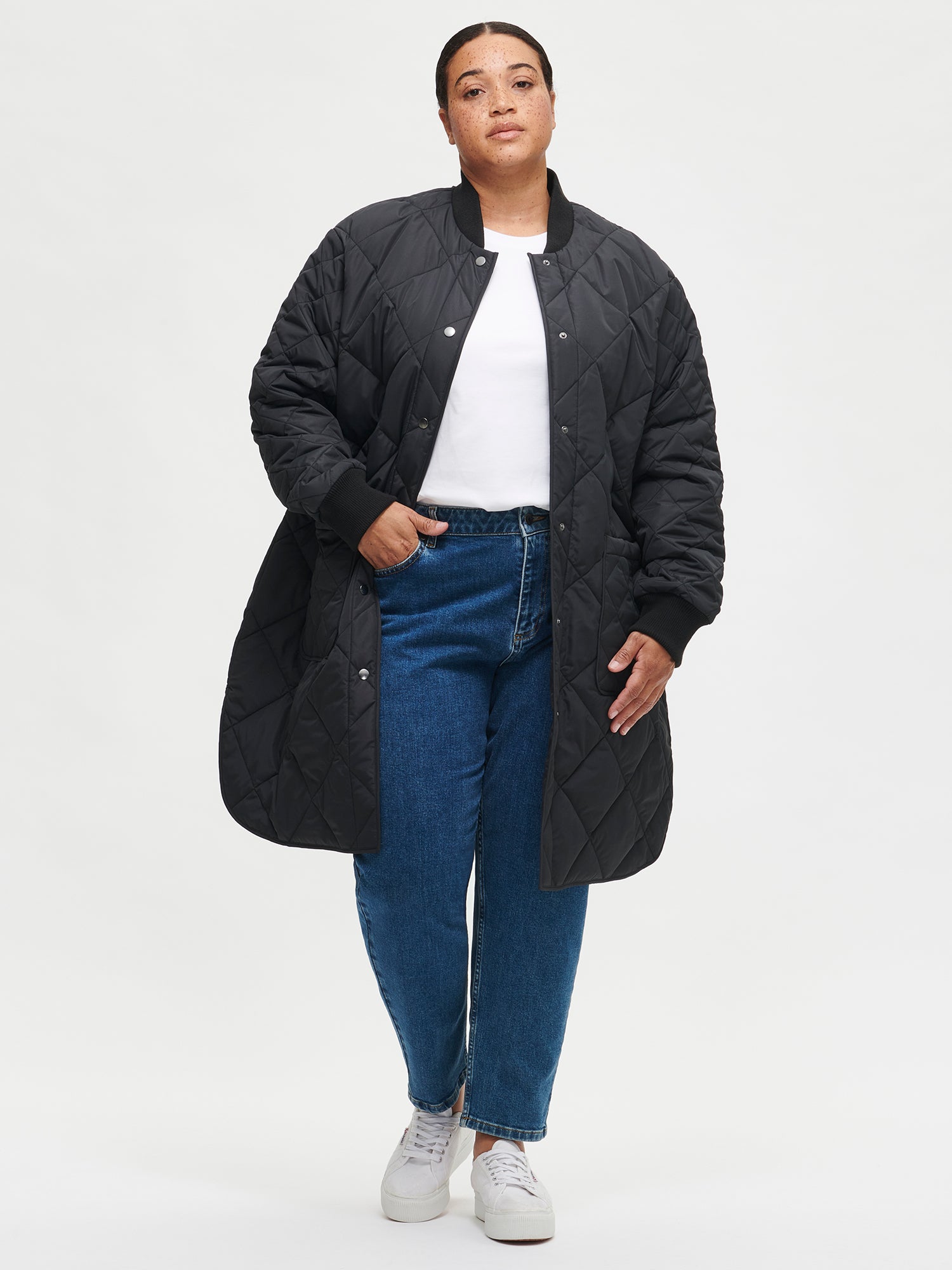 Nanso women's casual black Midi quilted coat on a model with jeans and a white shirt | XL - 172cm