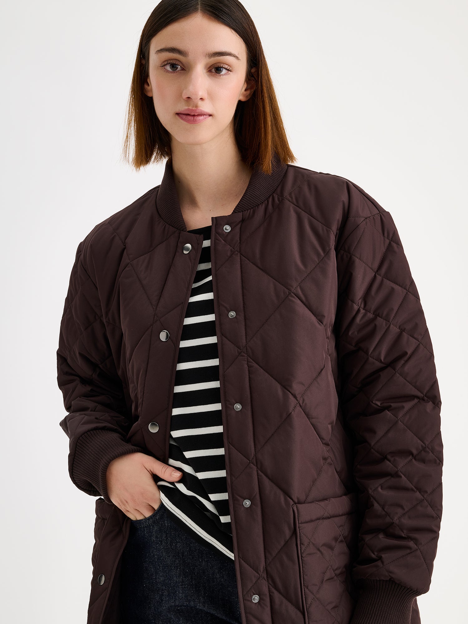 Nanso women's casual Midi quilted coat in brown on a brunette model with a striped shirt and blue jeans