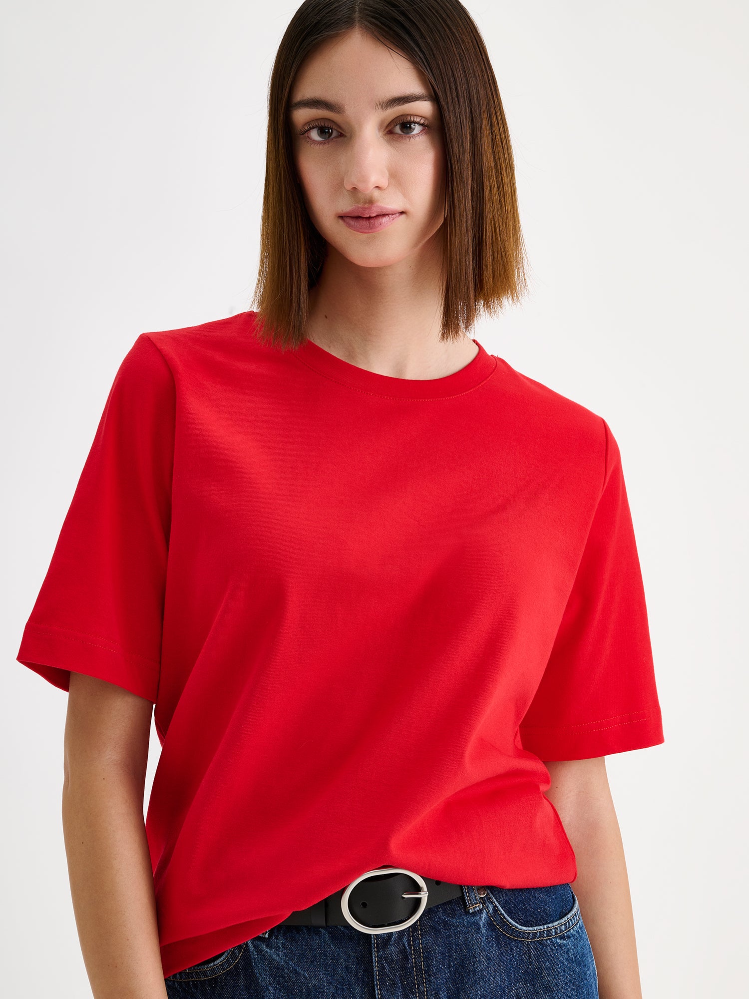 Women's Normi T-shirt in Red with relaxed fit and straightforward silhouette on a model, close-up.