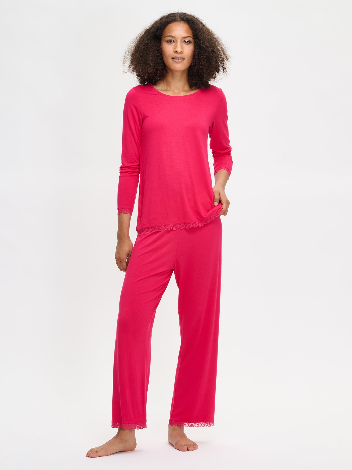 Women's pink Pitsi pants with pink Pitsi shirt on a model.