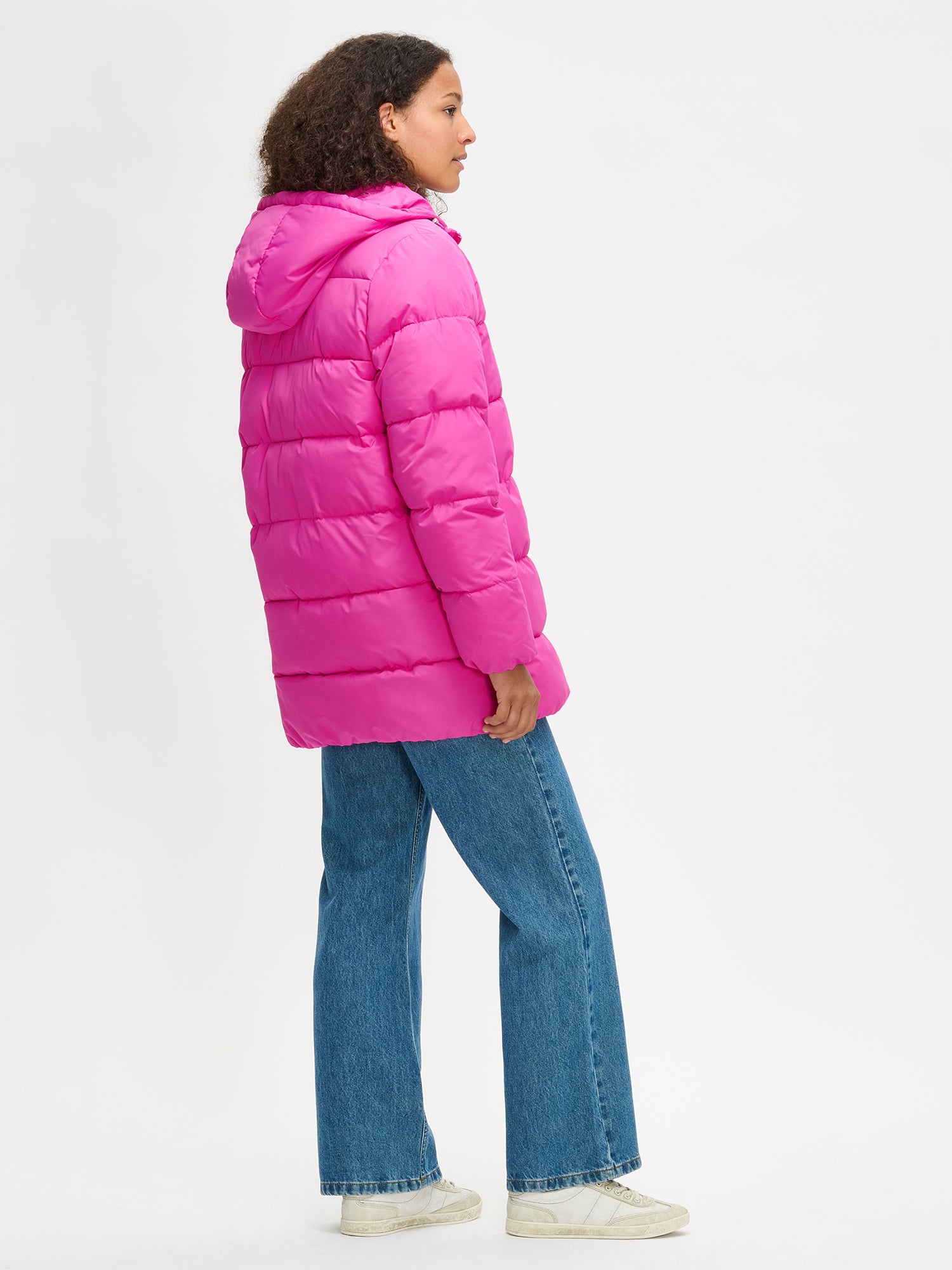 The pink Lumi padded coat provides warmth with its soft, lightweight padding and generous fit, from the front.