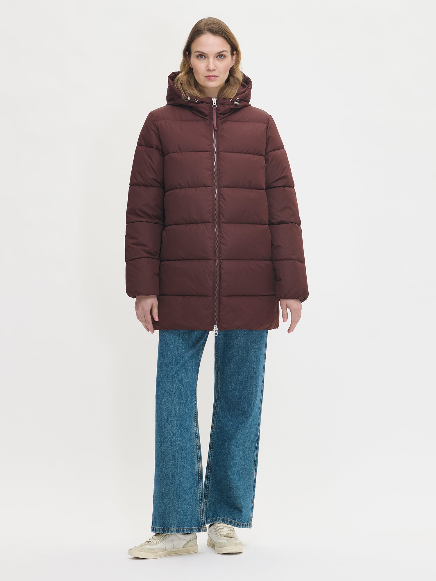 The dark brown Lumi padded coat provides warmth with its soft, lightweight padding and generous fit. Worn by a model in size S.