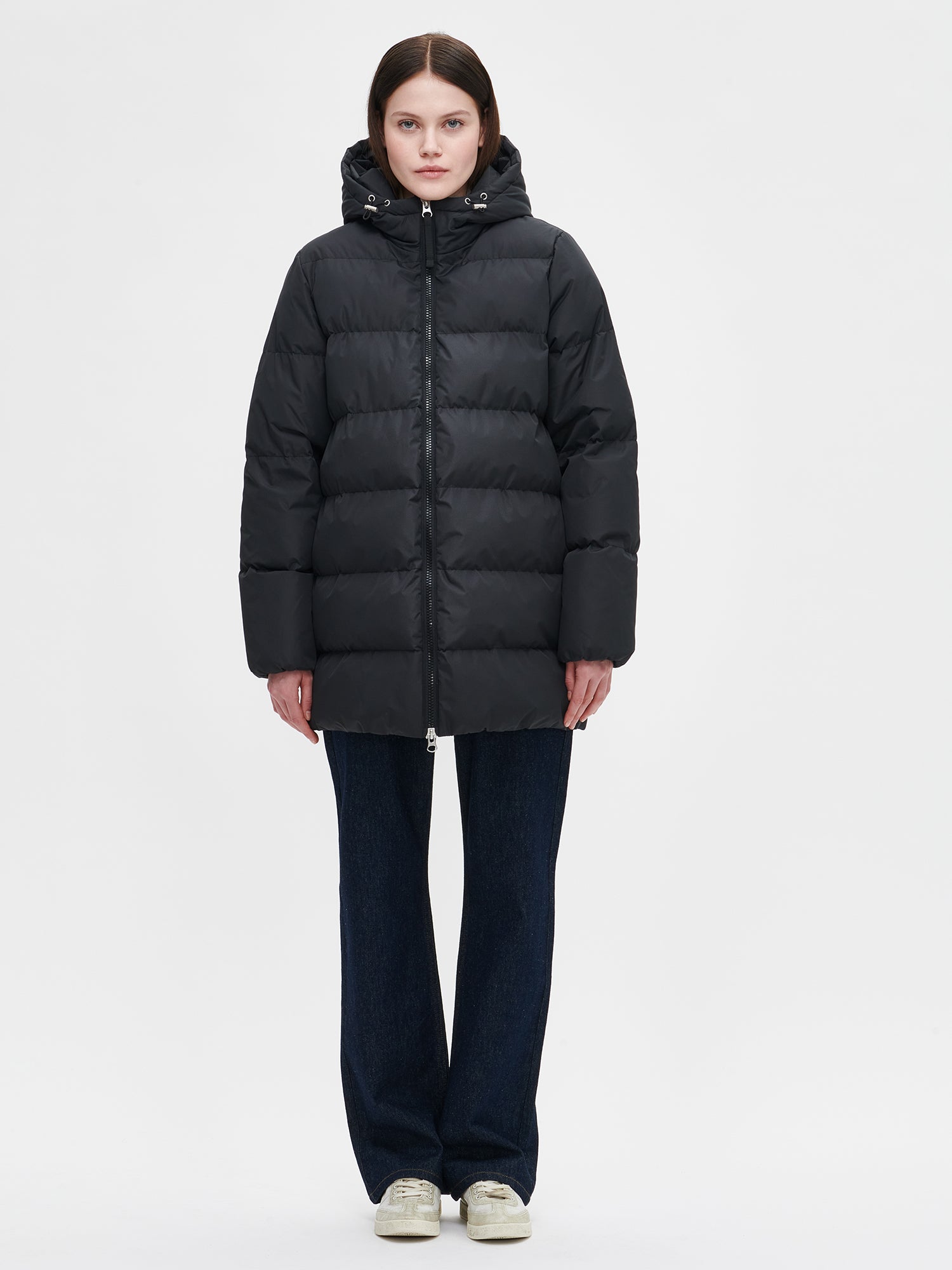 The black Lumi padded coat provides warmth with its soft, lightweight padding and generous fit, worn by a model in size S.