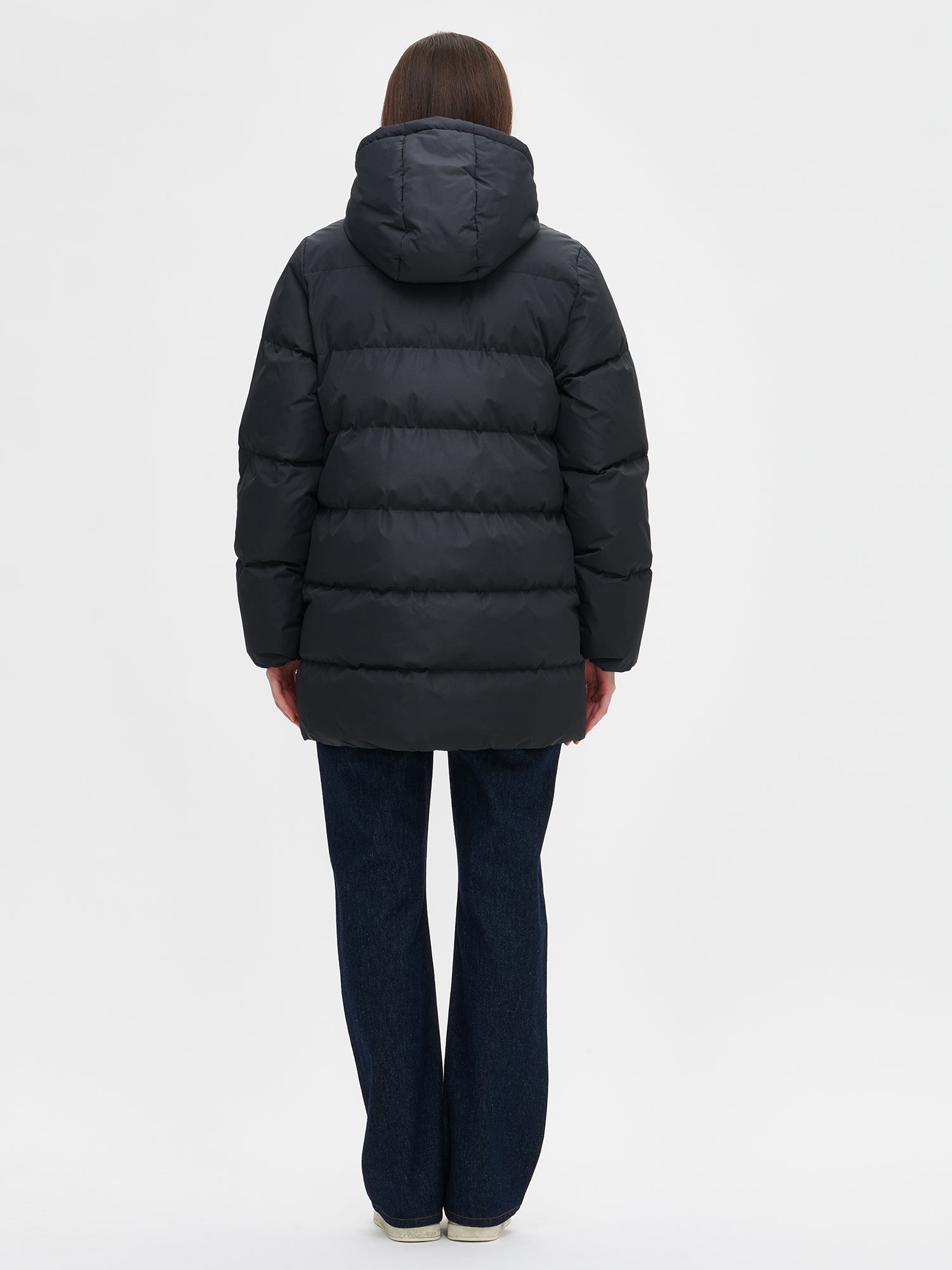 The black Lumi padded coat provides warmth with its soft, lightweight padding and generous fit, from the back.