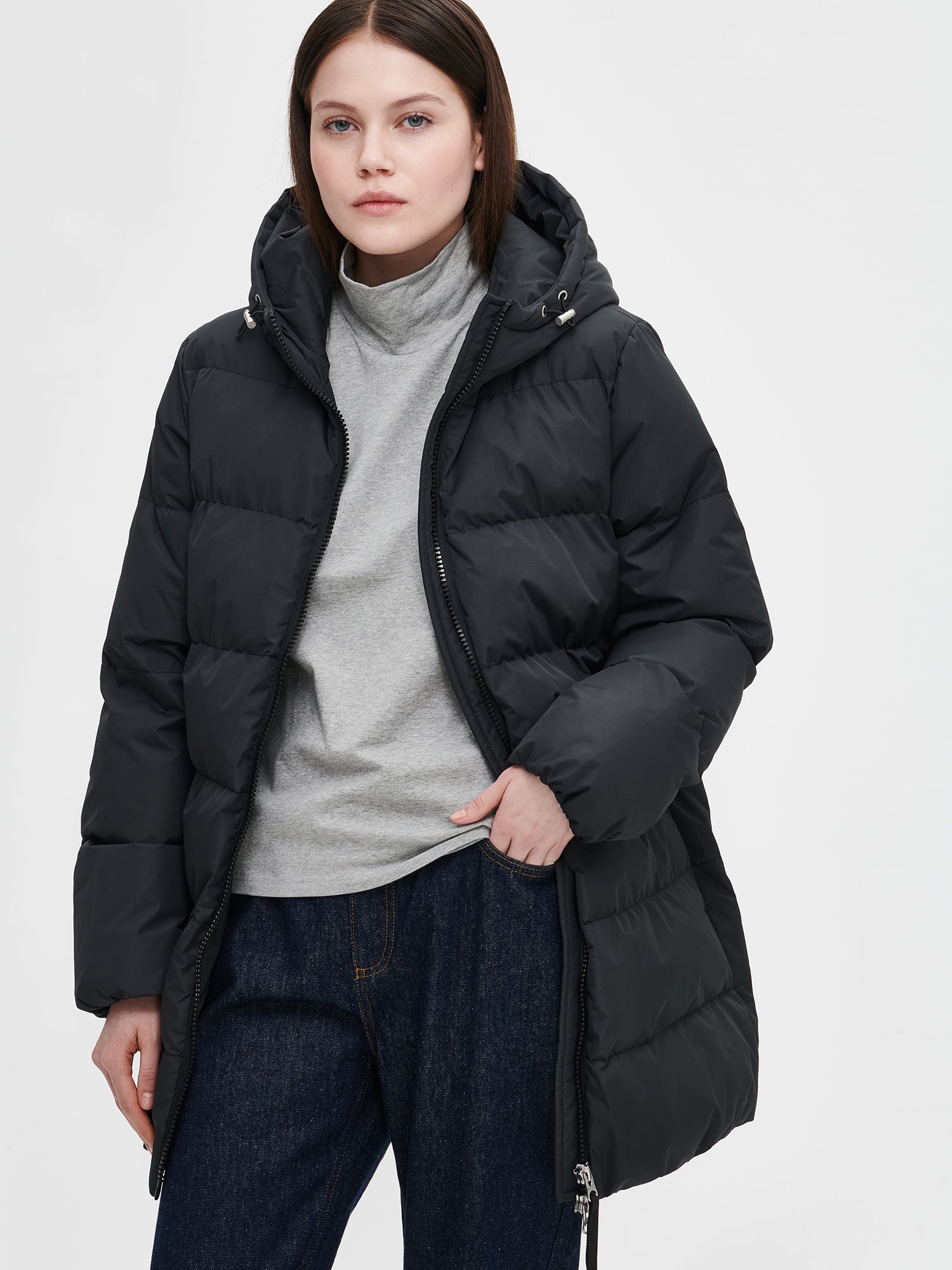 The black Lumi padded coat provides warmth with its soft, lightweight padding and generous fit, from the front.