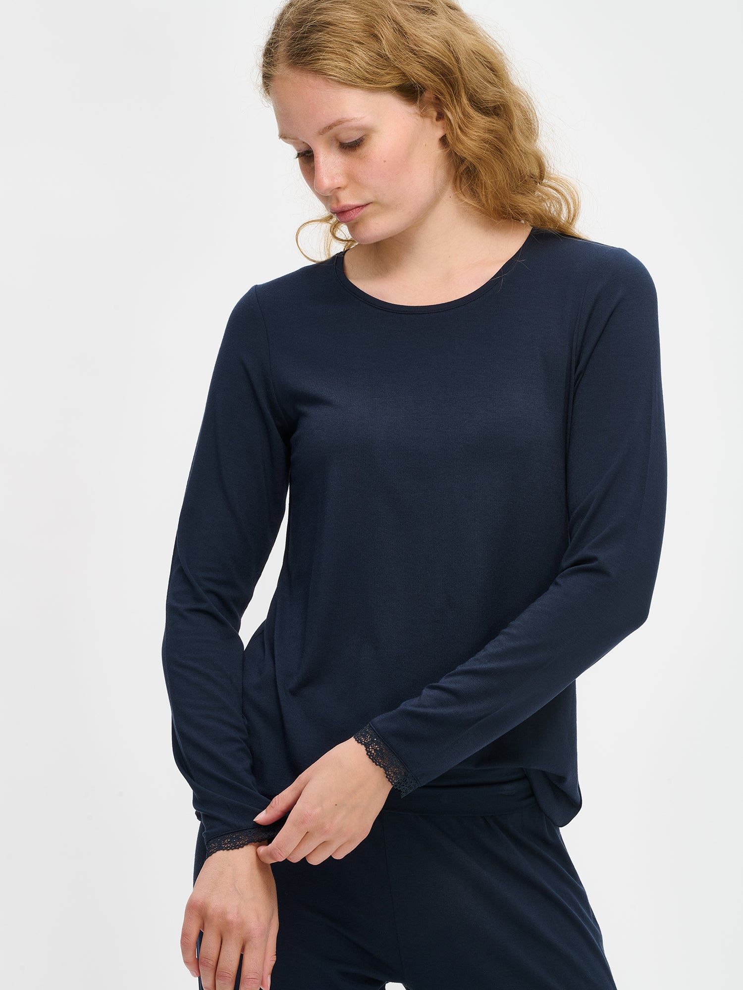 Dark blue Pitsi shirt with long sleeves and a round neckline on a model in a close-up picture. The model wears the dark blue Pitsi pants as well.