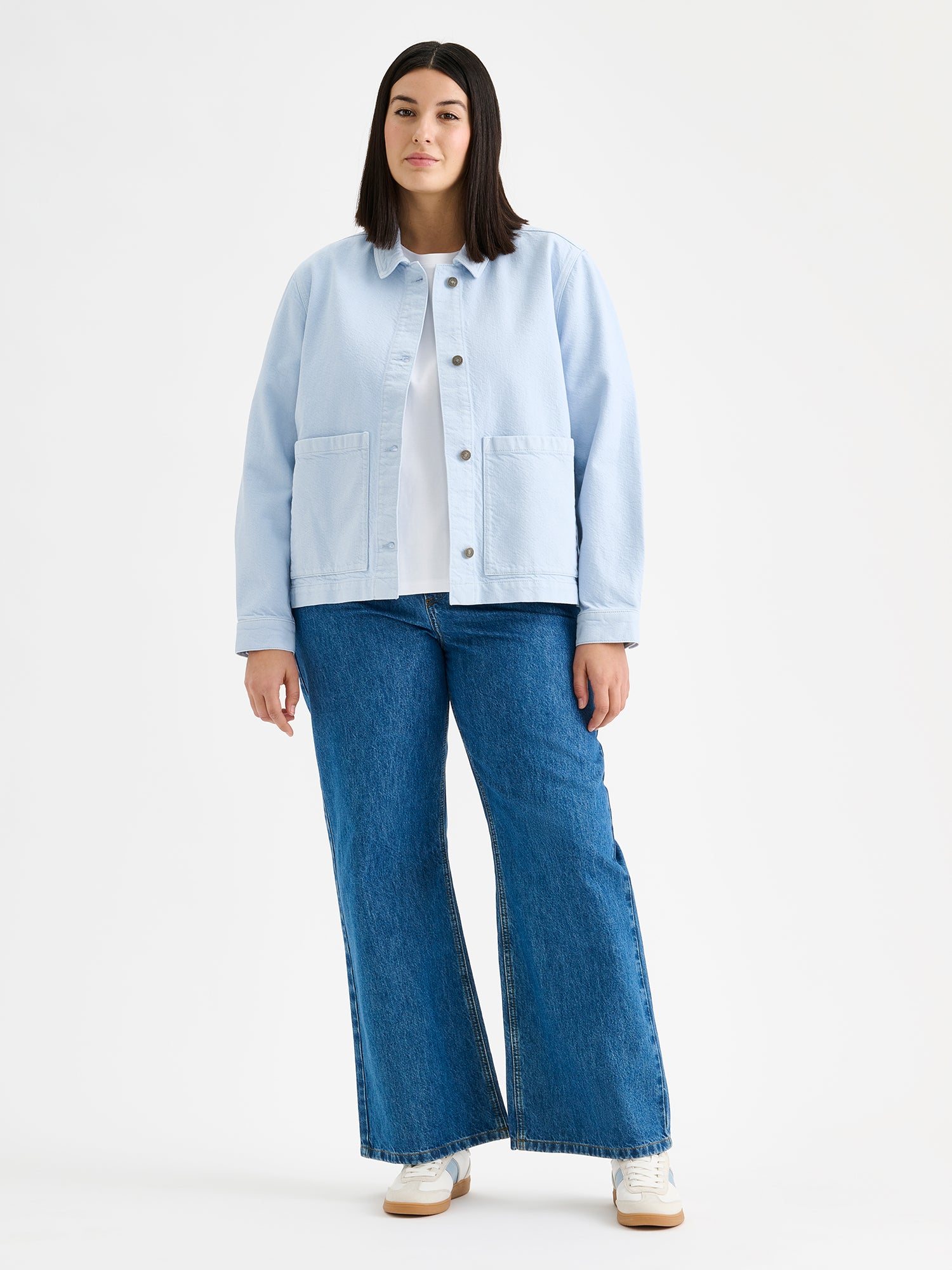 Nanso women's relaxed short MIMI jacket in a beautiful blue shade on a model with jeans.