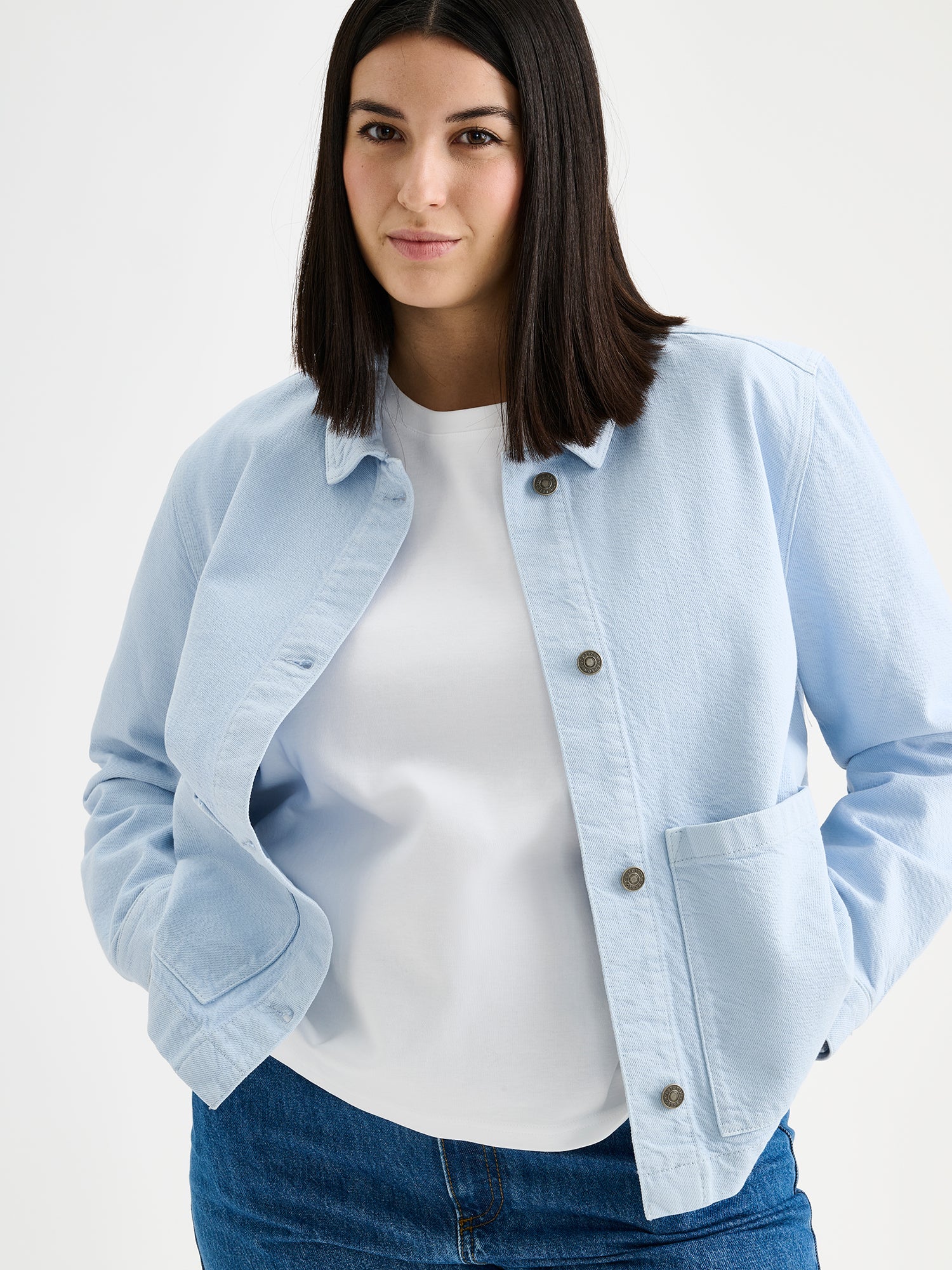 Nanso women's relaxed short MIMI jacket in a beautiful blue shade on a model with jeans.