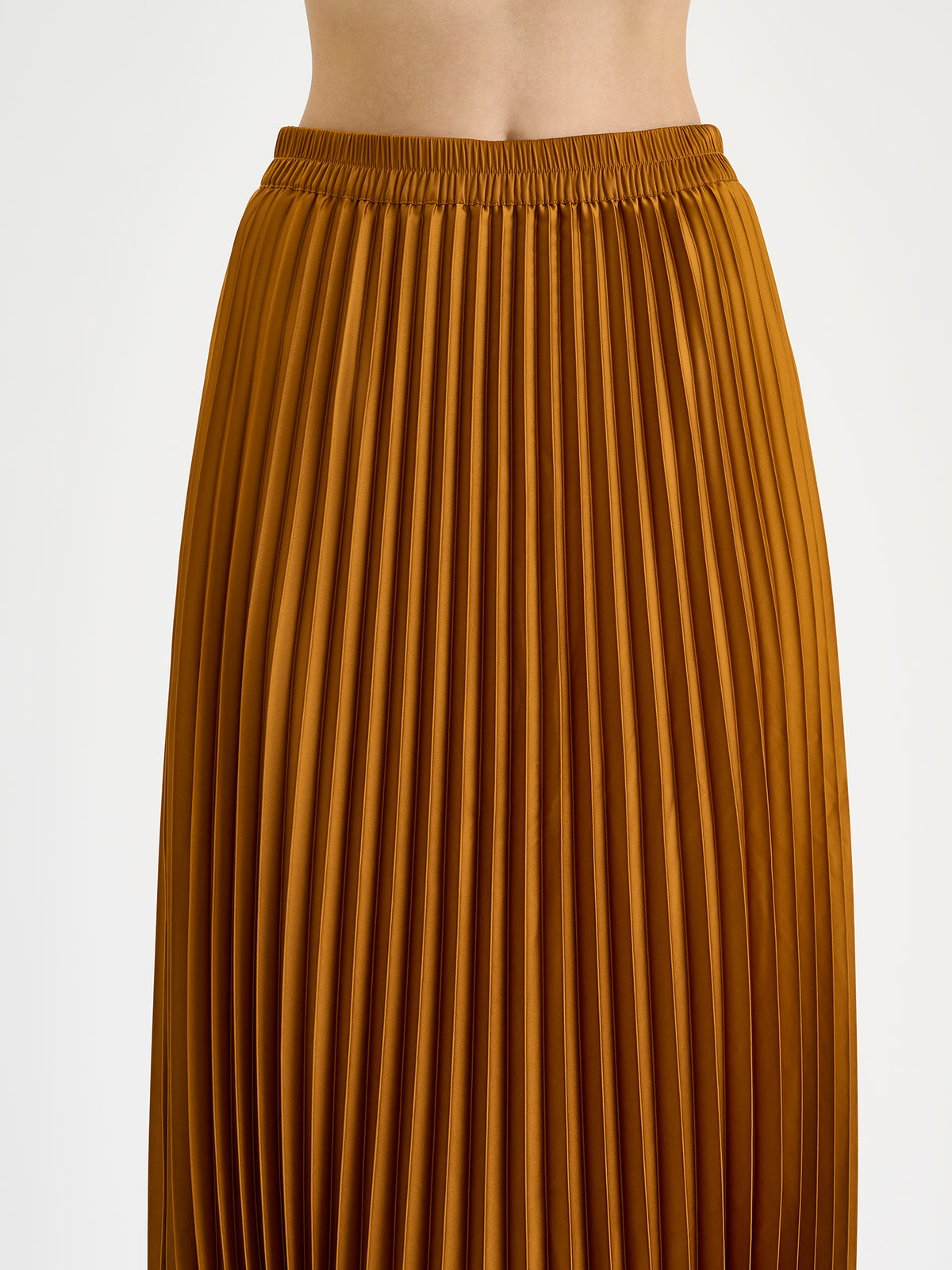 Nanso's elegant Taite skirt for women features a graceful drape in a rich brown shade, pictured on a model close-up.