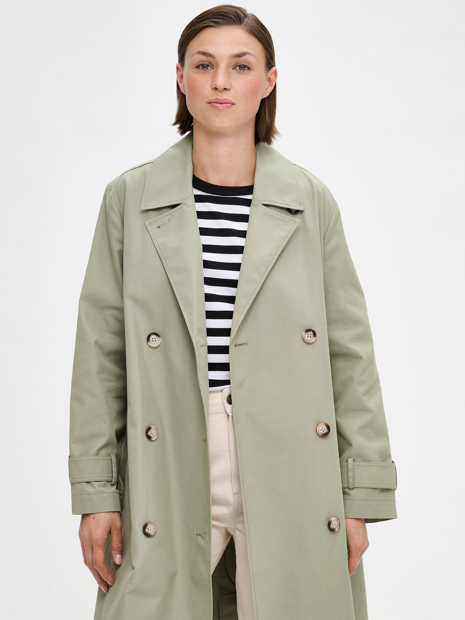 A timeless Light Green trench coat on a model 
